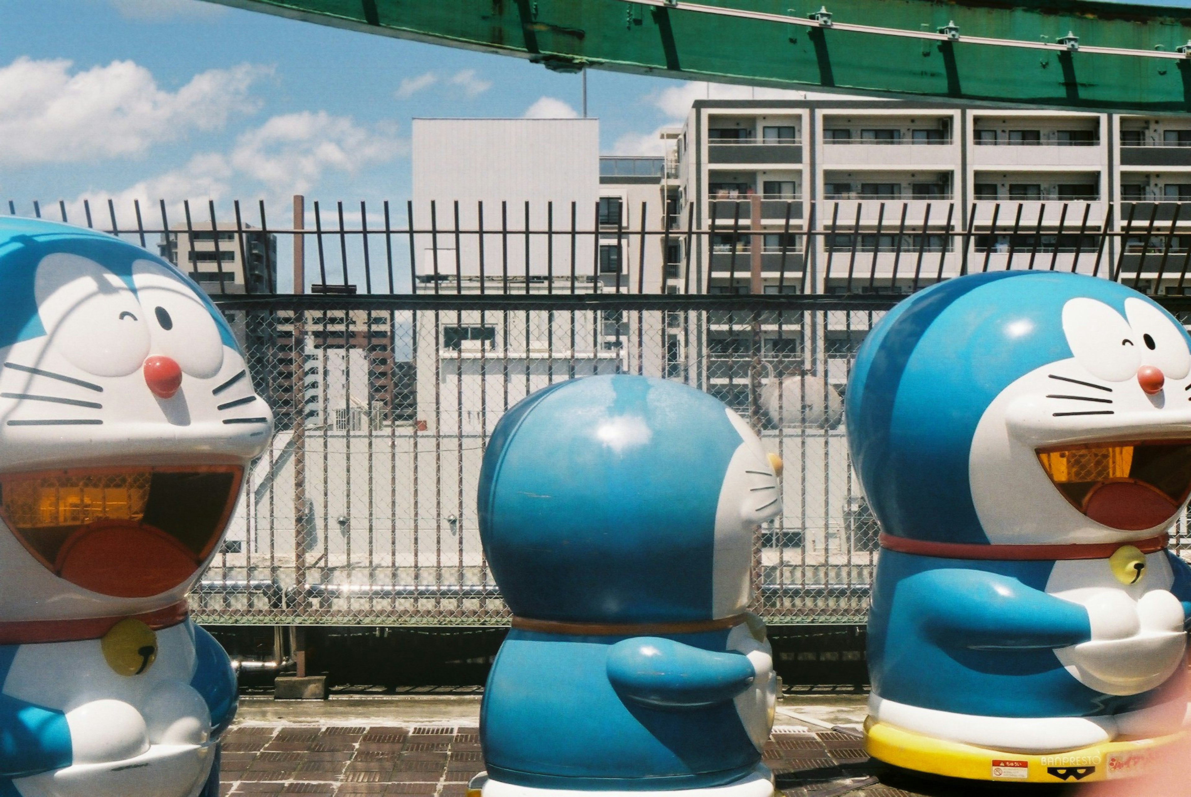 Three blue robot characters in an outdoor setting