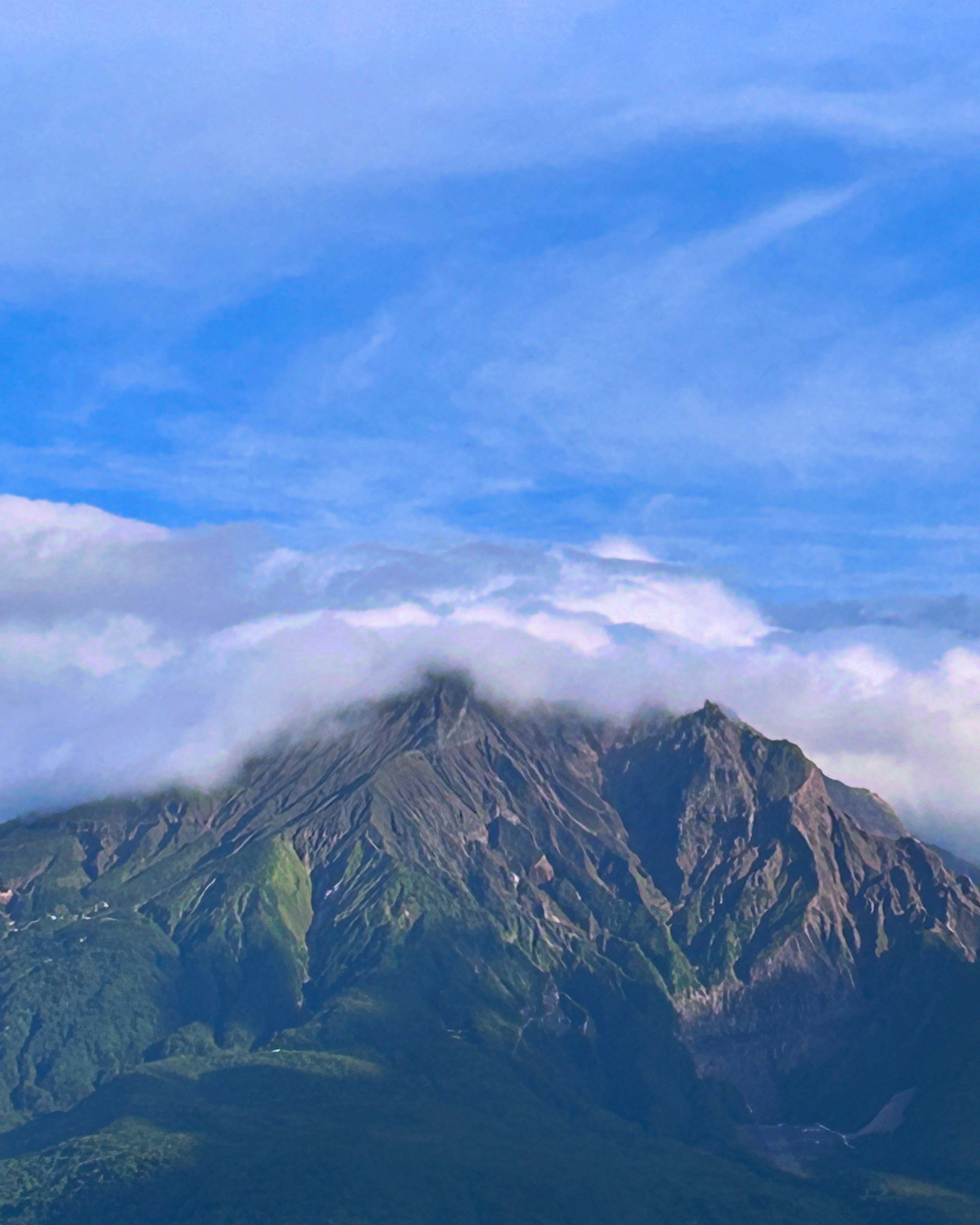 Mountain landscape under a blue sky with clouds