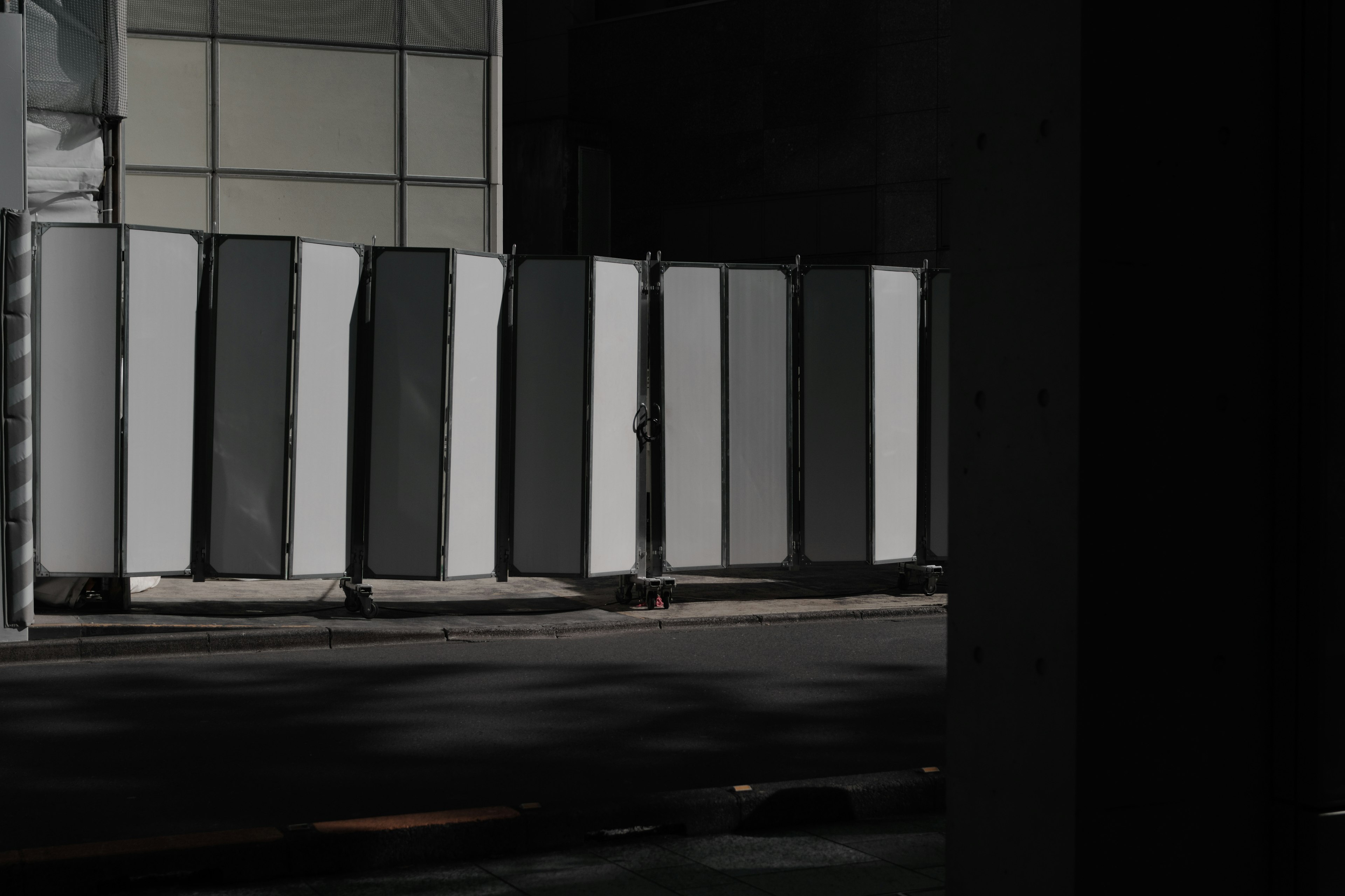 A scene with white and black panels lined up against a dark background