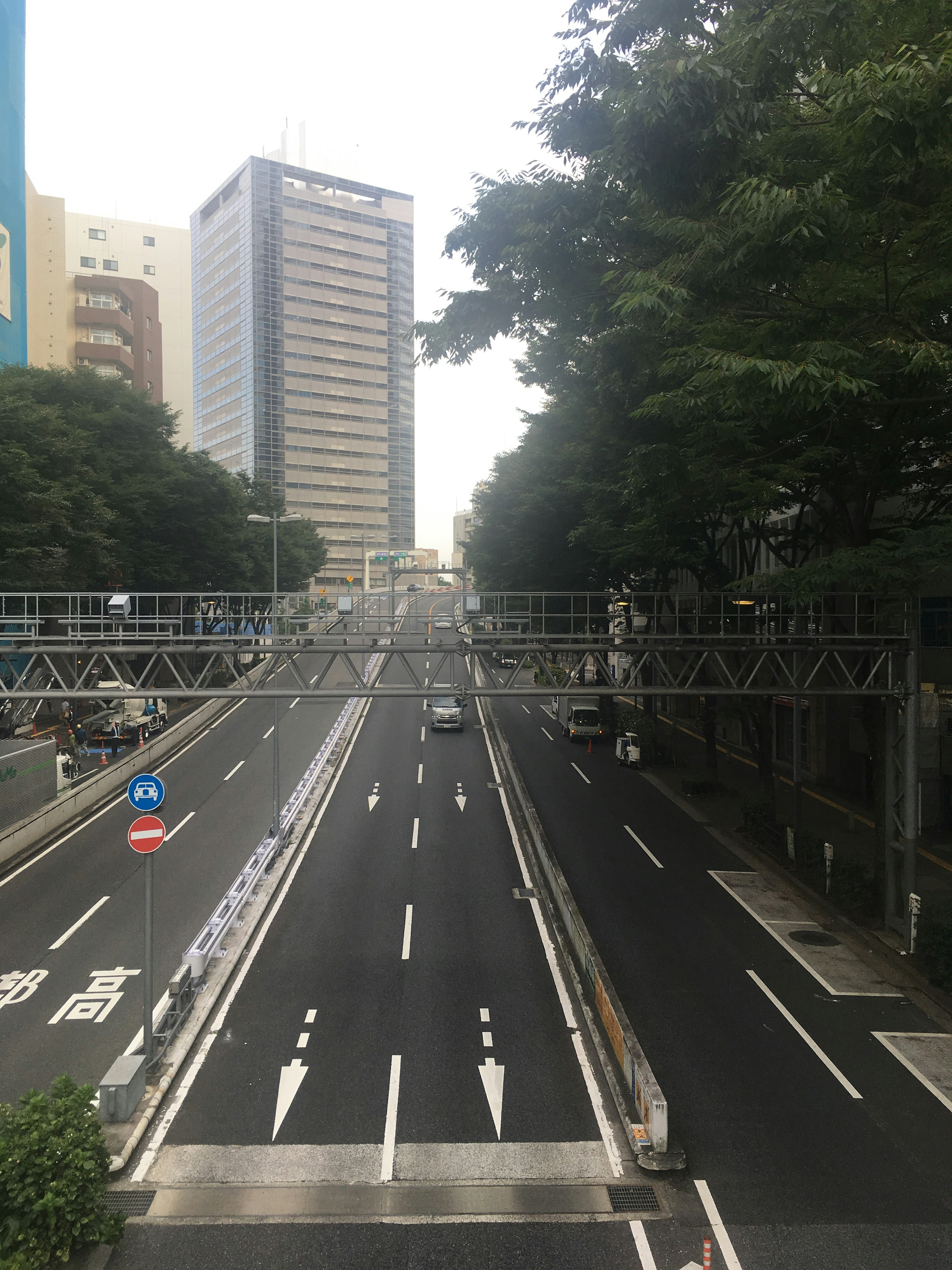 Urban road surrounded by buildings and trees