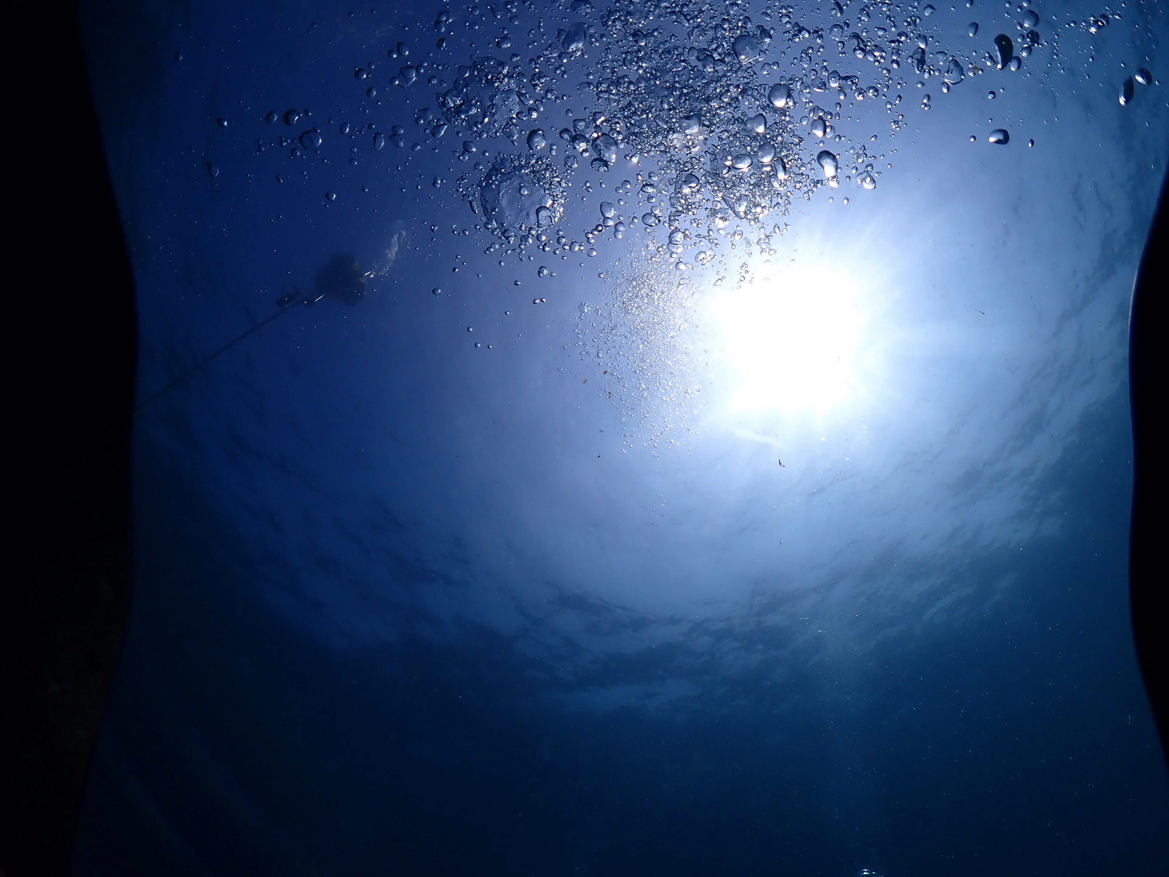 Underwater image showing blue light and bubbles