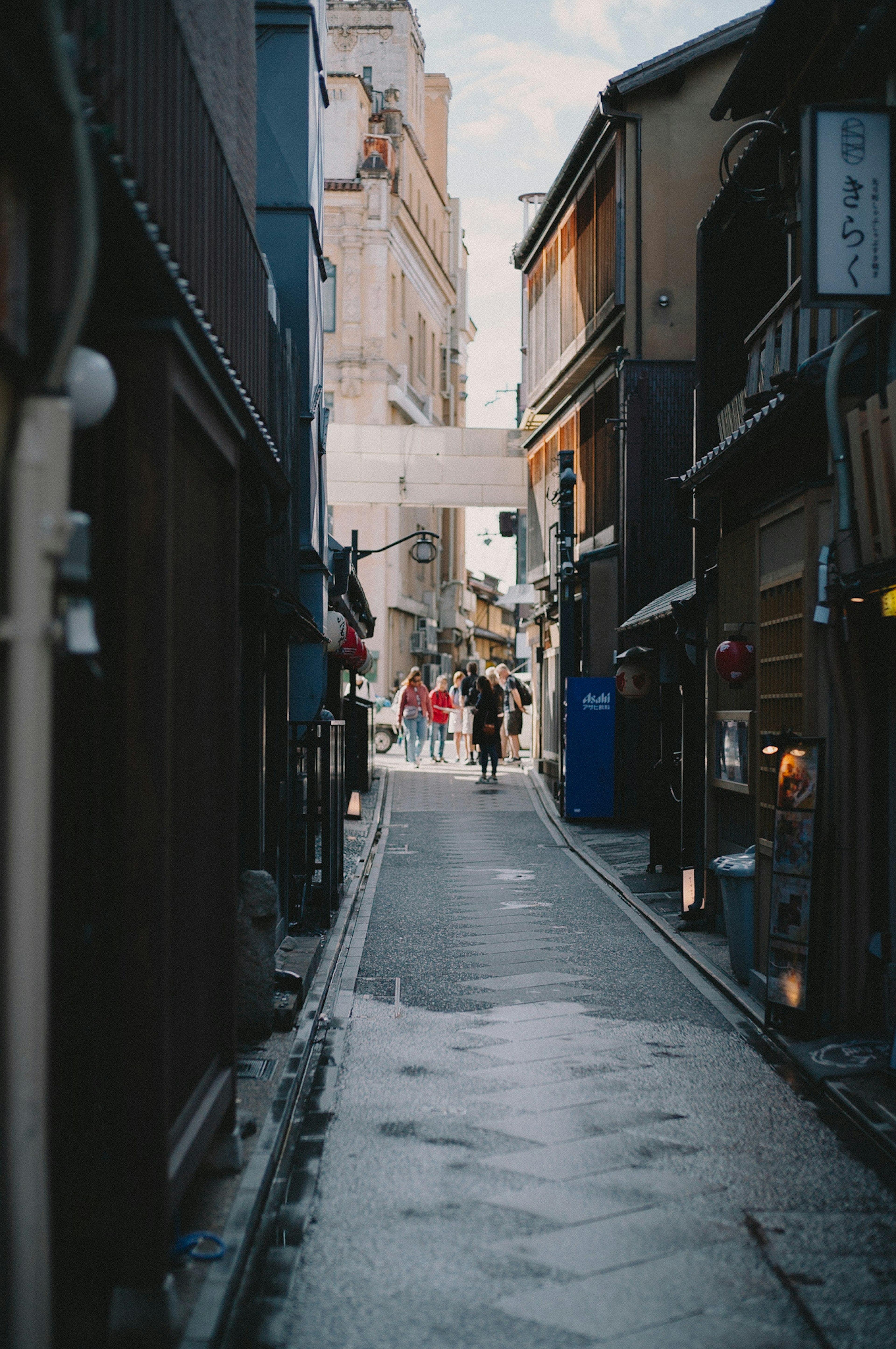 Narrow alley with people walking through