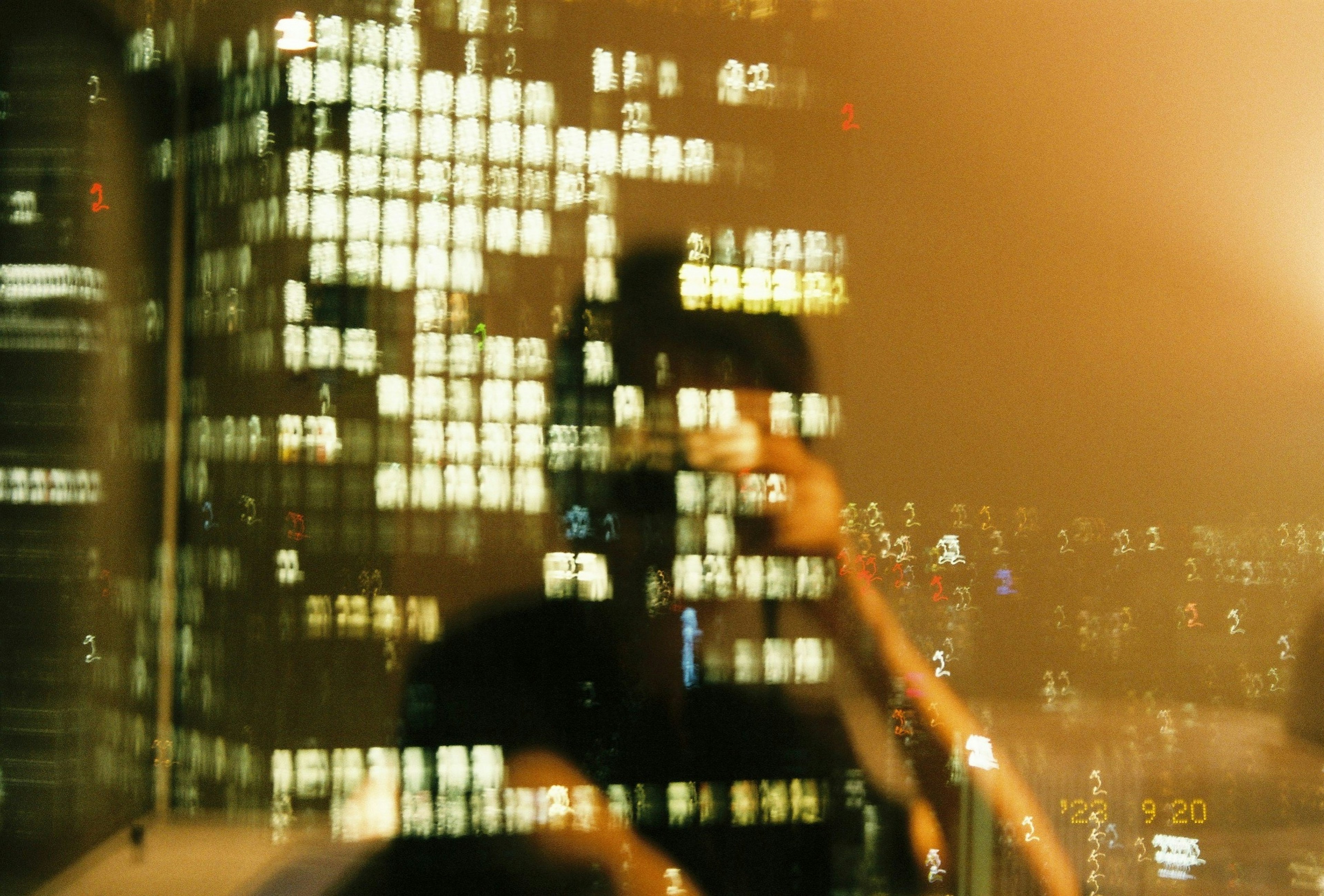 Blurry reflection of buildings and city skyline at night