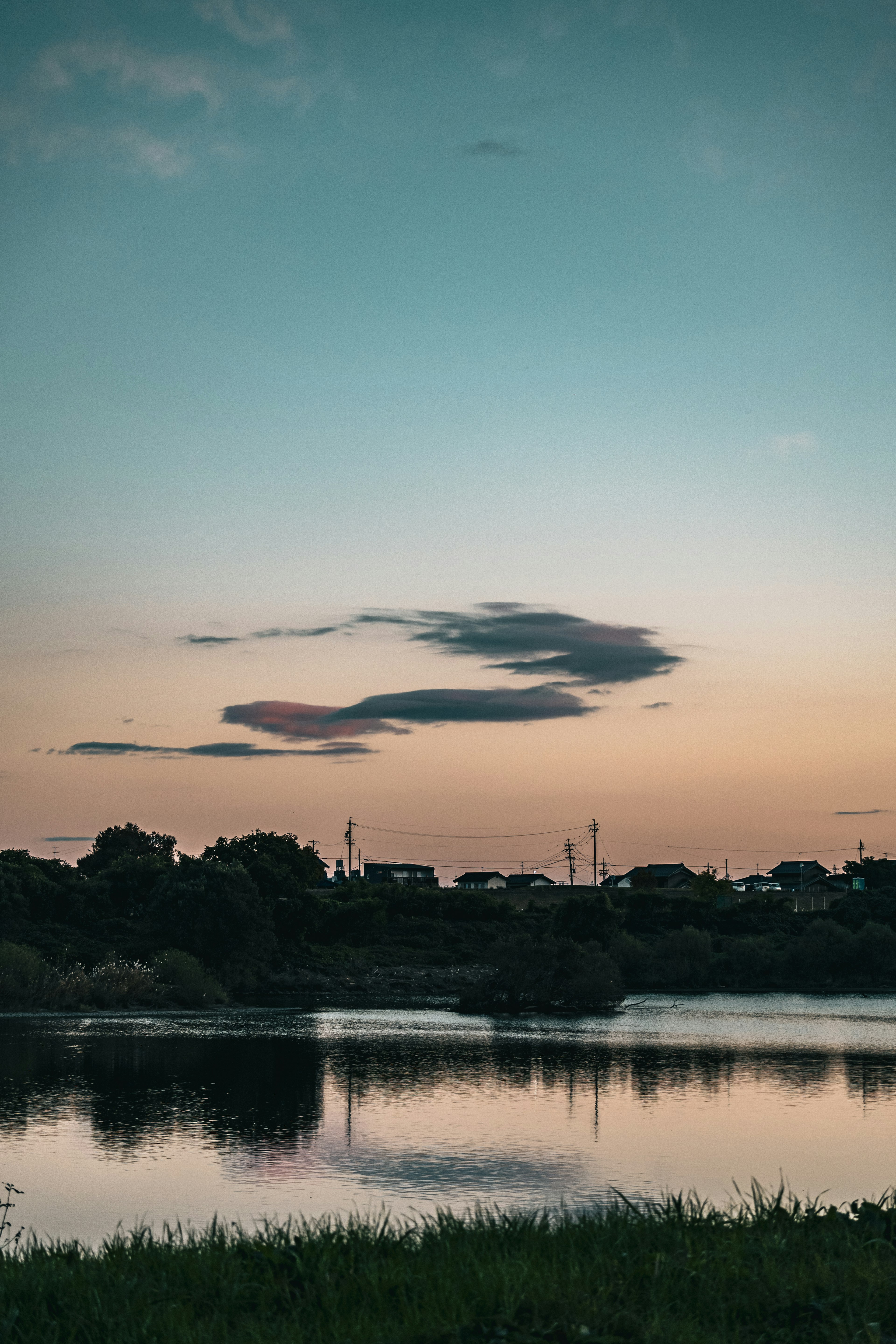 夕焼けの川の風景と映る雲