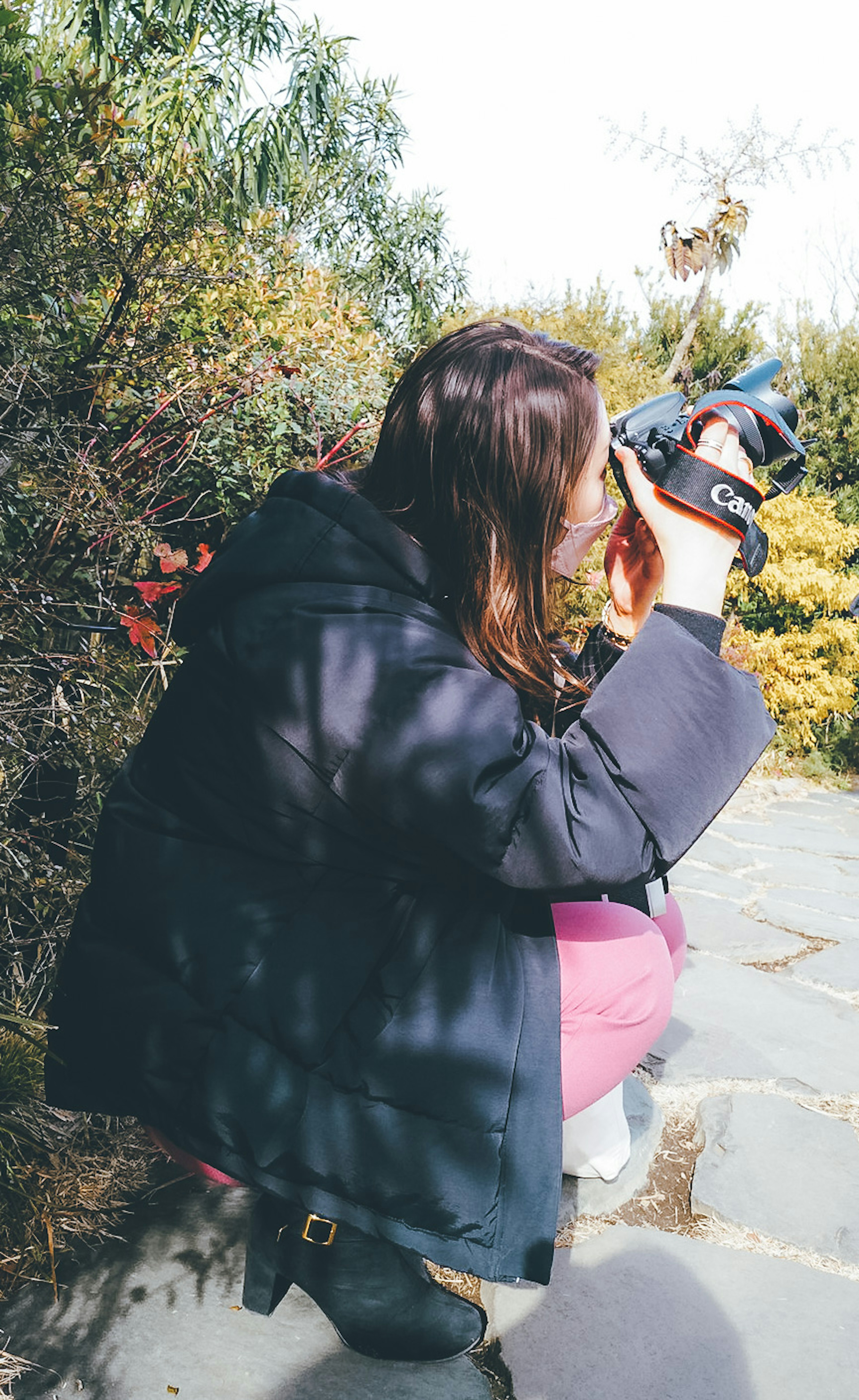 Woman taking photos of plants with a camera