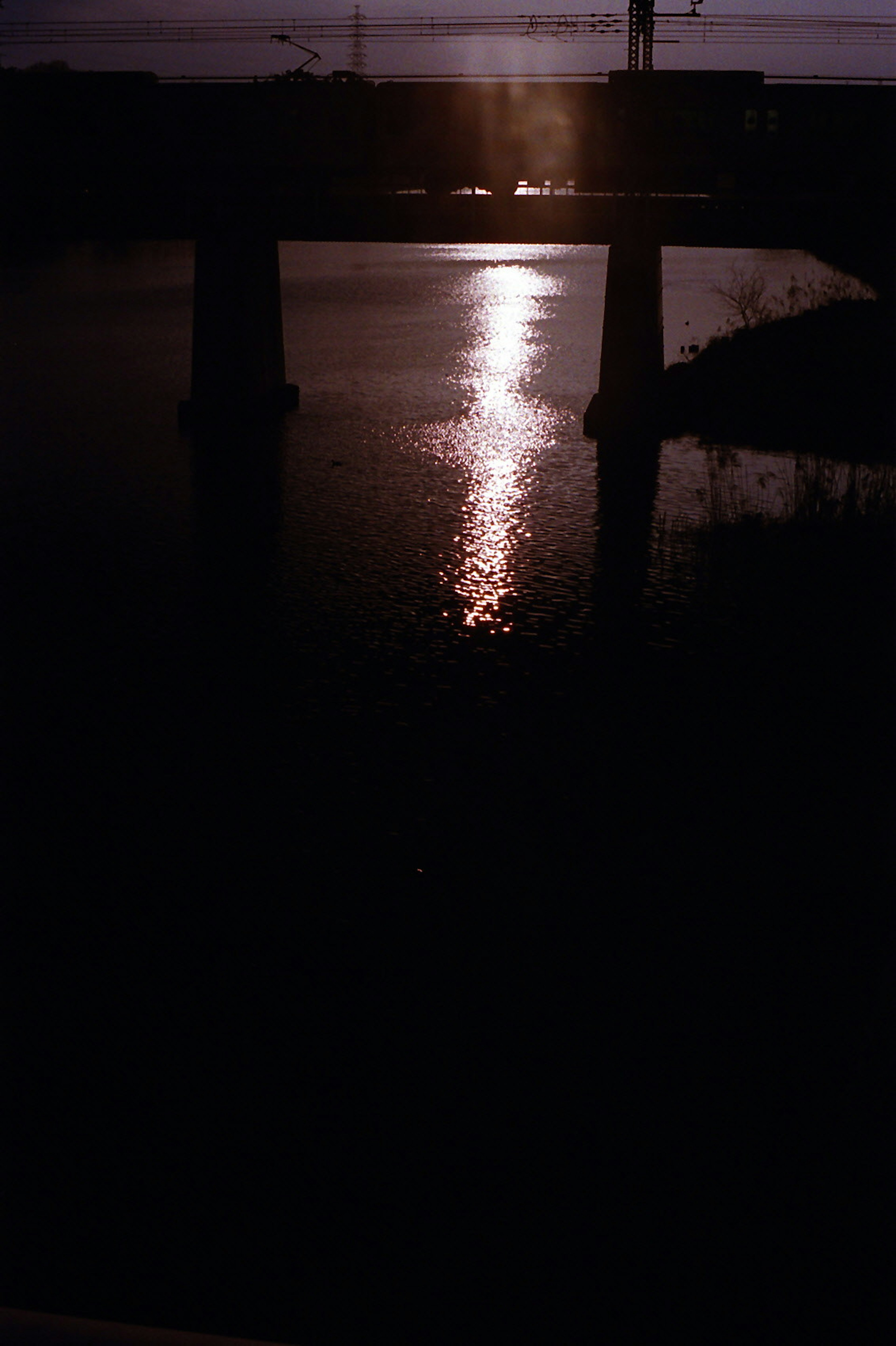 Bridge at dusk with reflections on the water