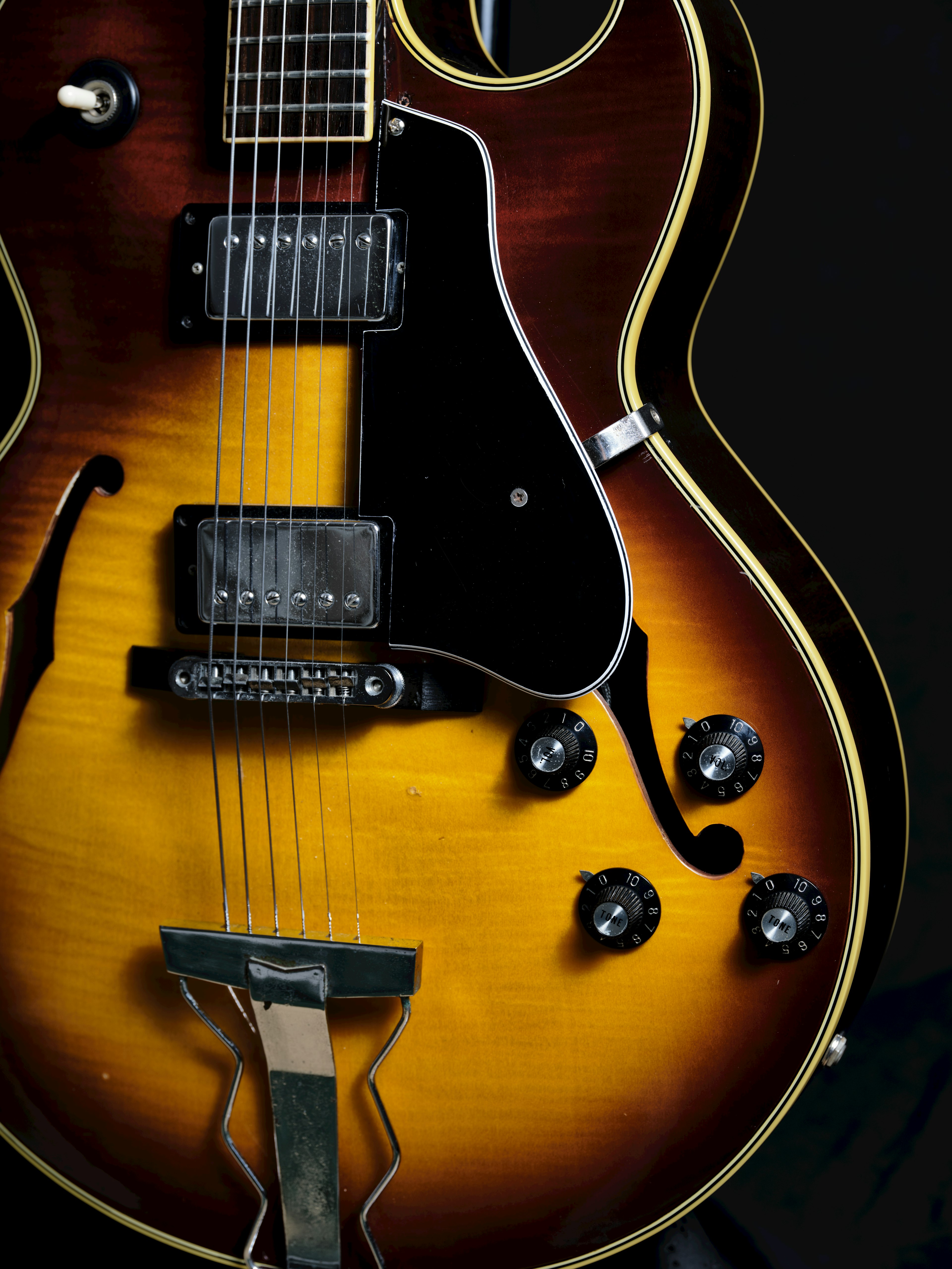 Close-up of an electric guitar with a black background