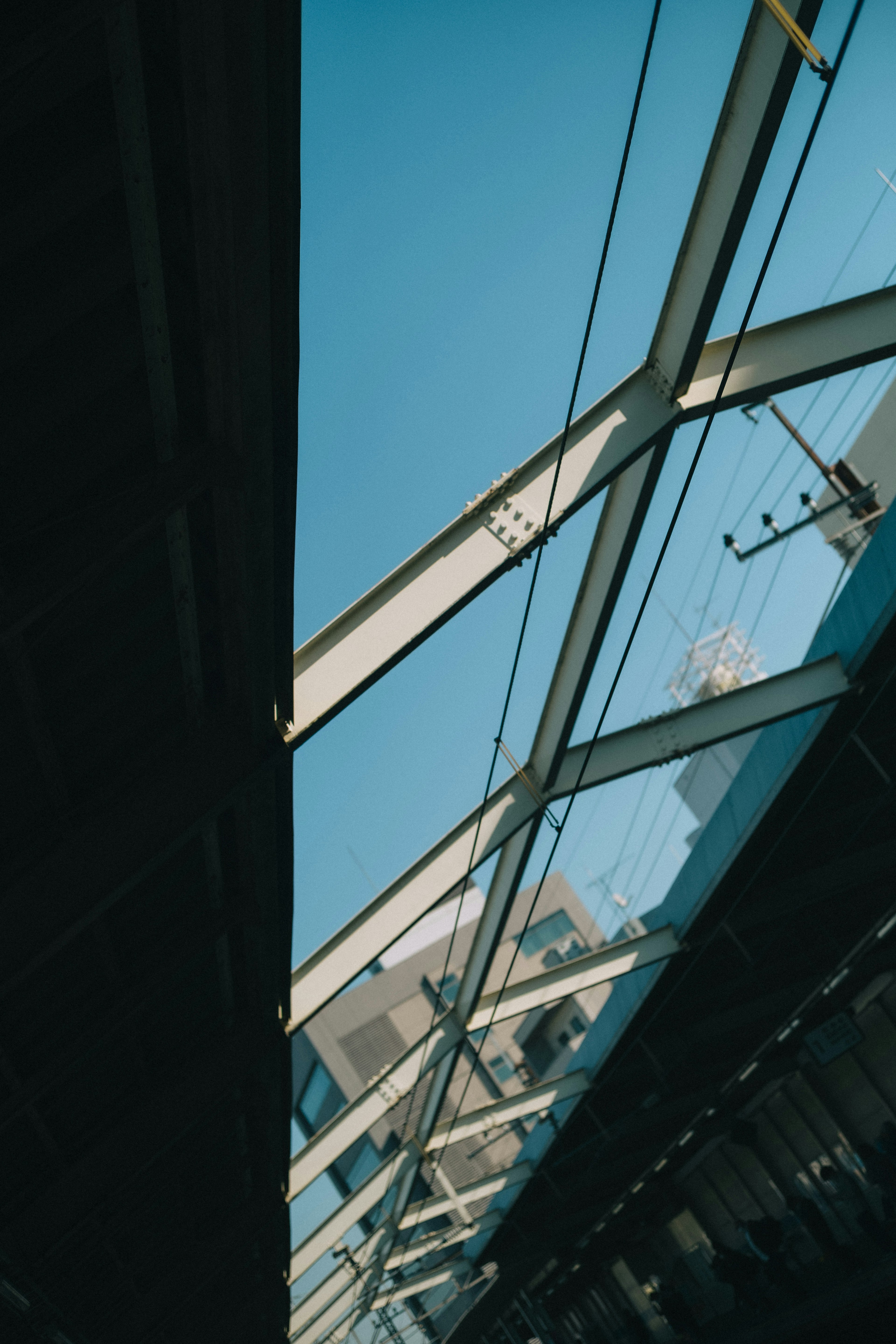 Railway structure and glass roof under blue sky