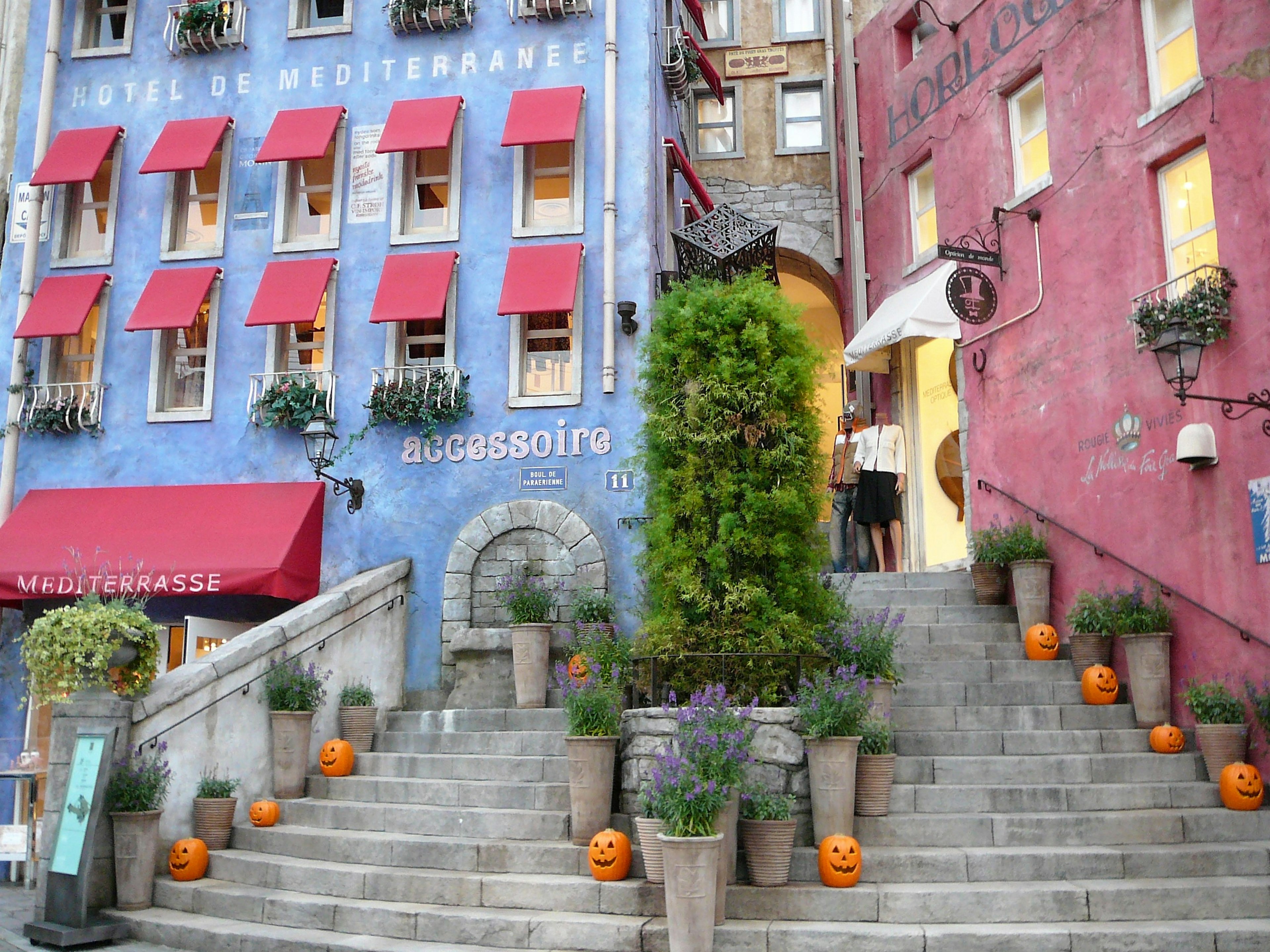 Colorful buildings with Halloween pumpkins along the staircase