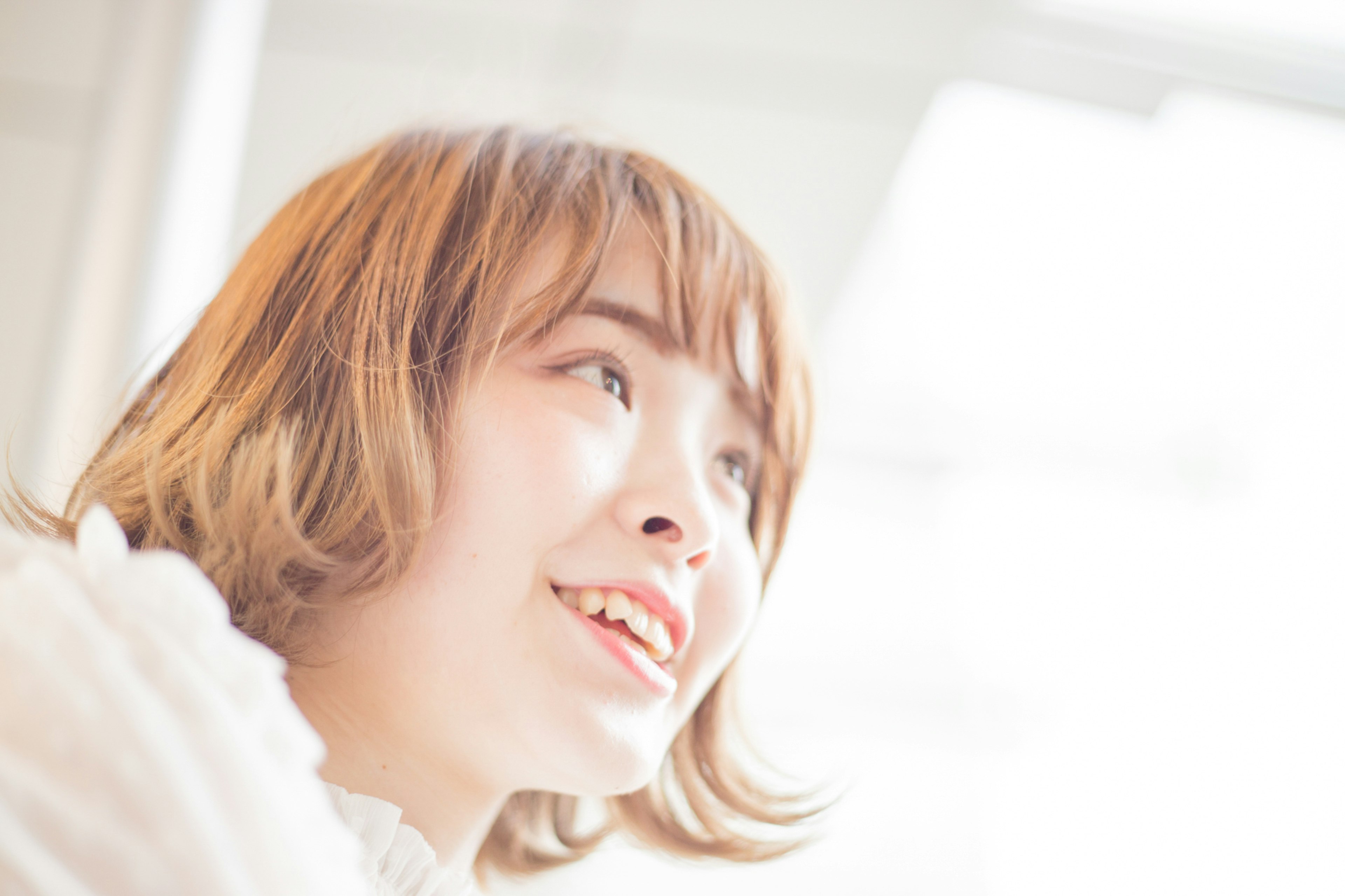 Portrait of a smiling woman with a bright background