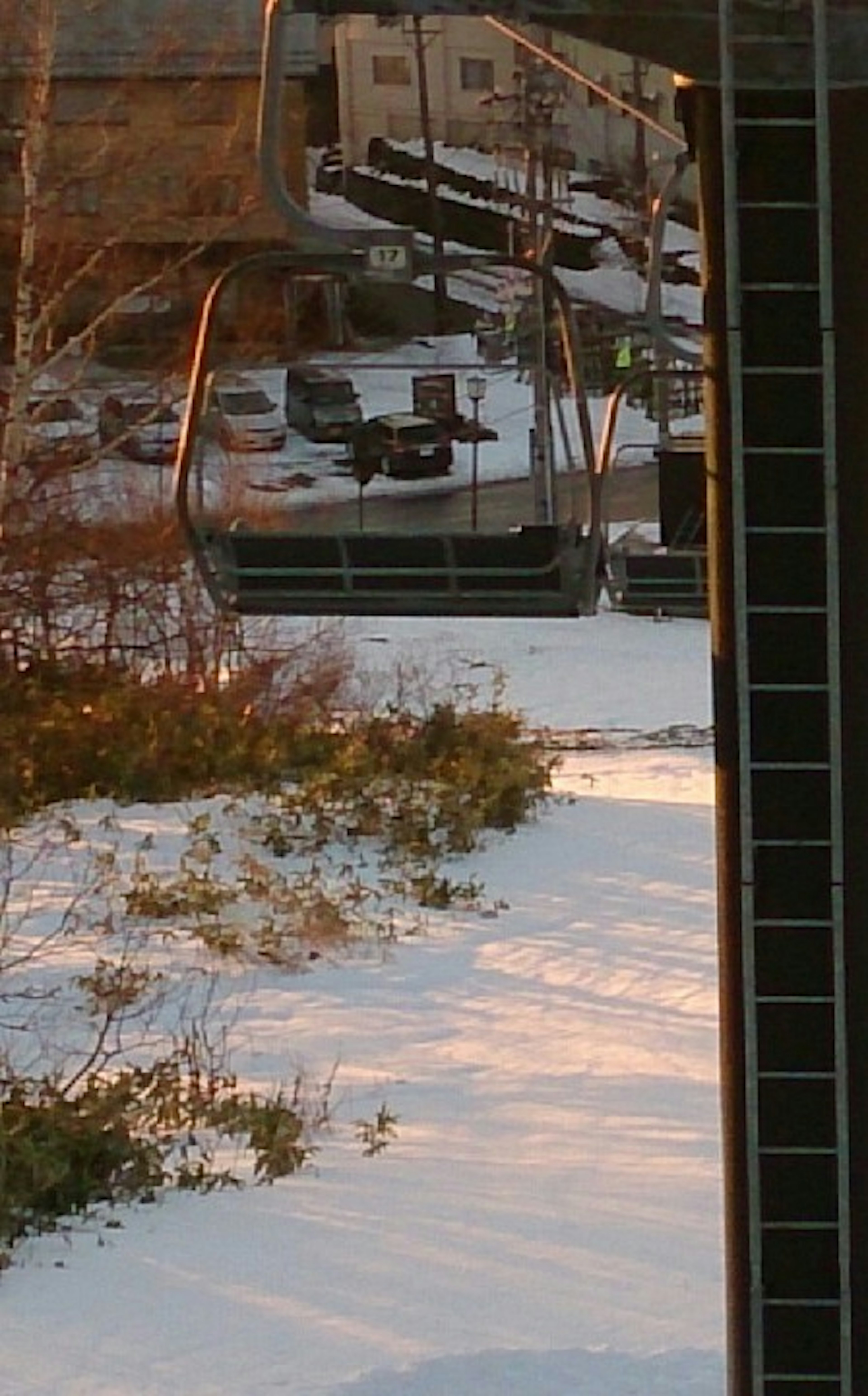 Snow-covered landscape with a reflection of a ski lift