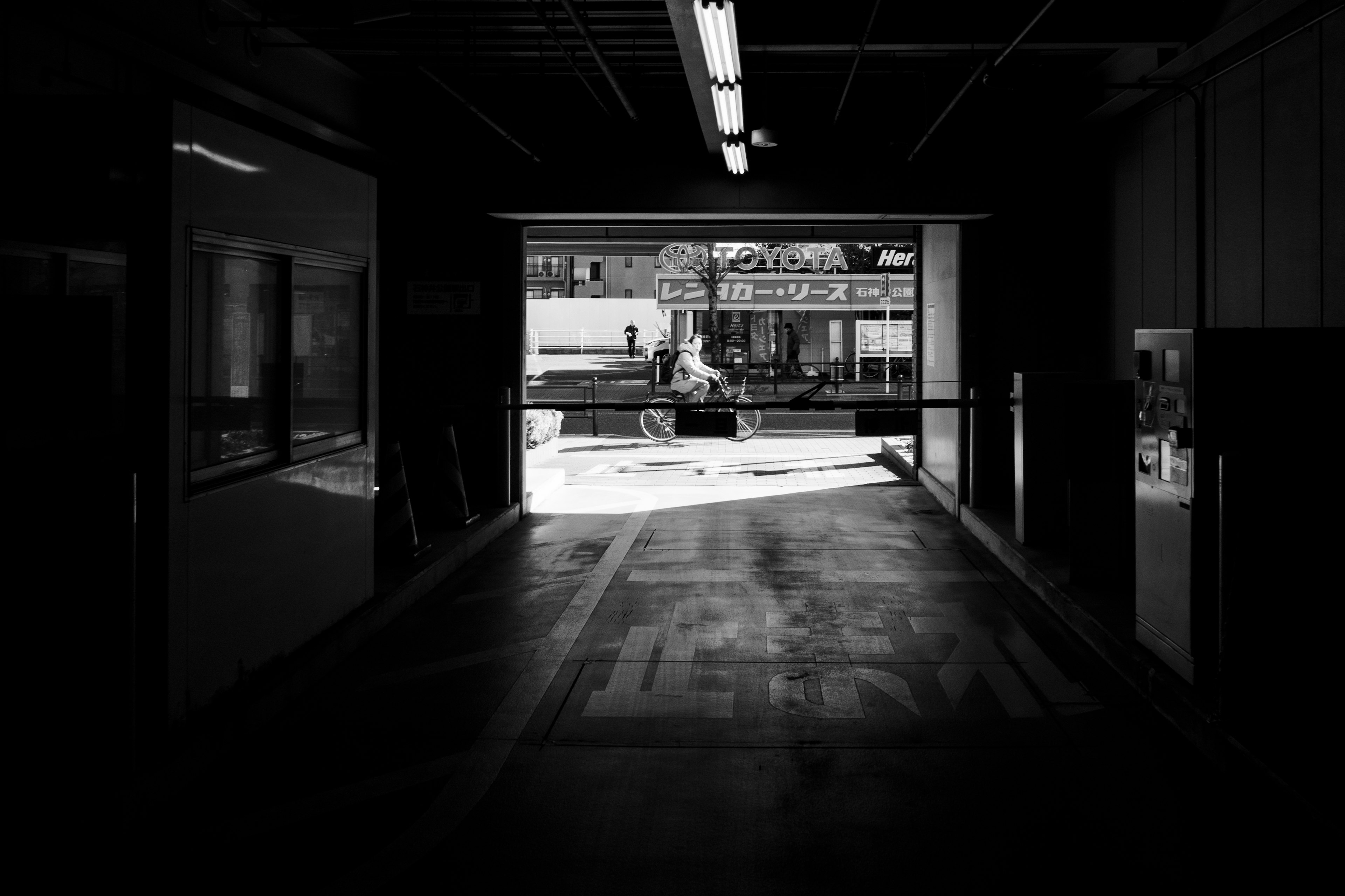 Dark corridor leading to a bright outdoor scene