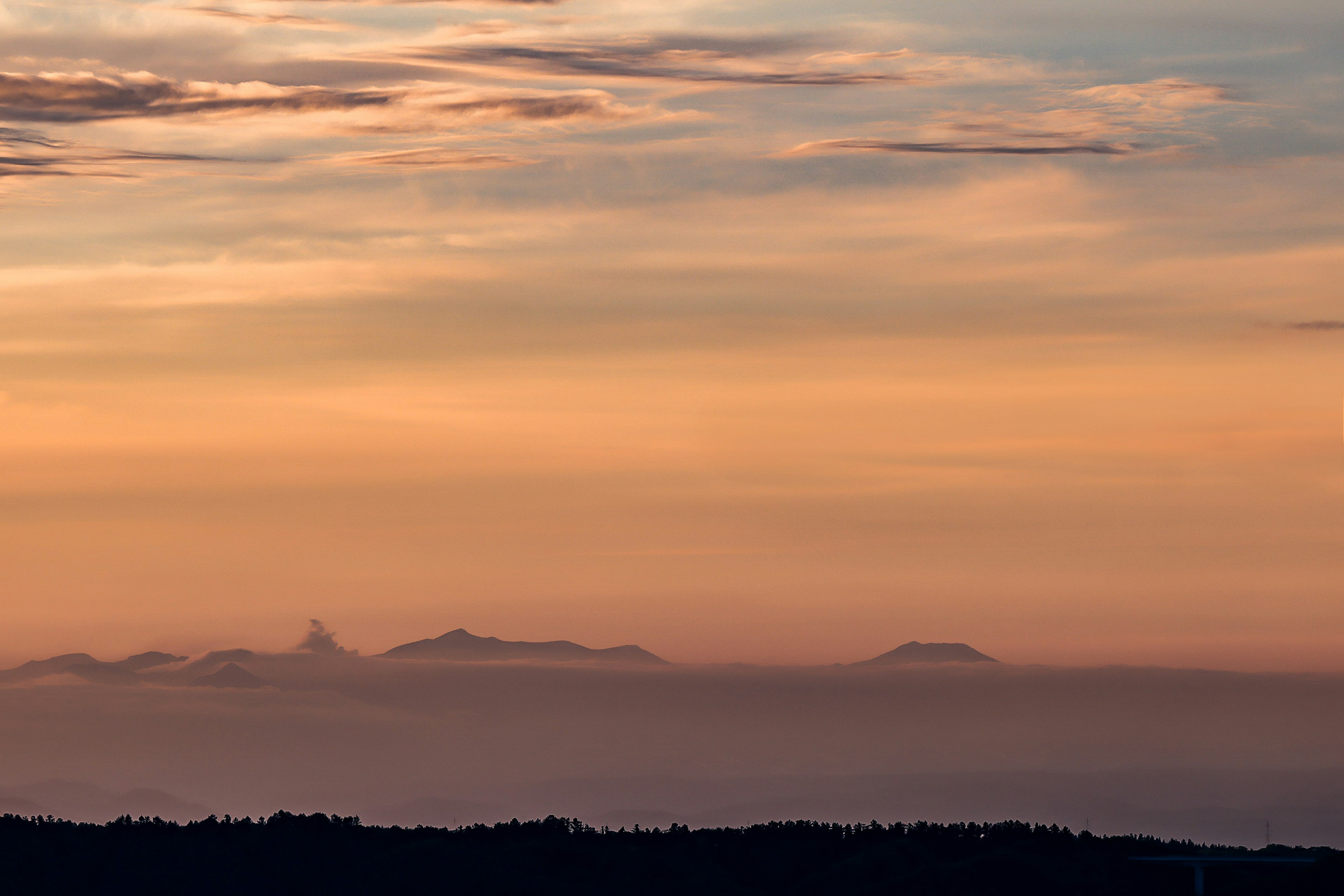 Schöner Sonnenuntergangshimmel mit Silhouetten entfernter Inseln