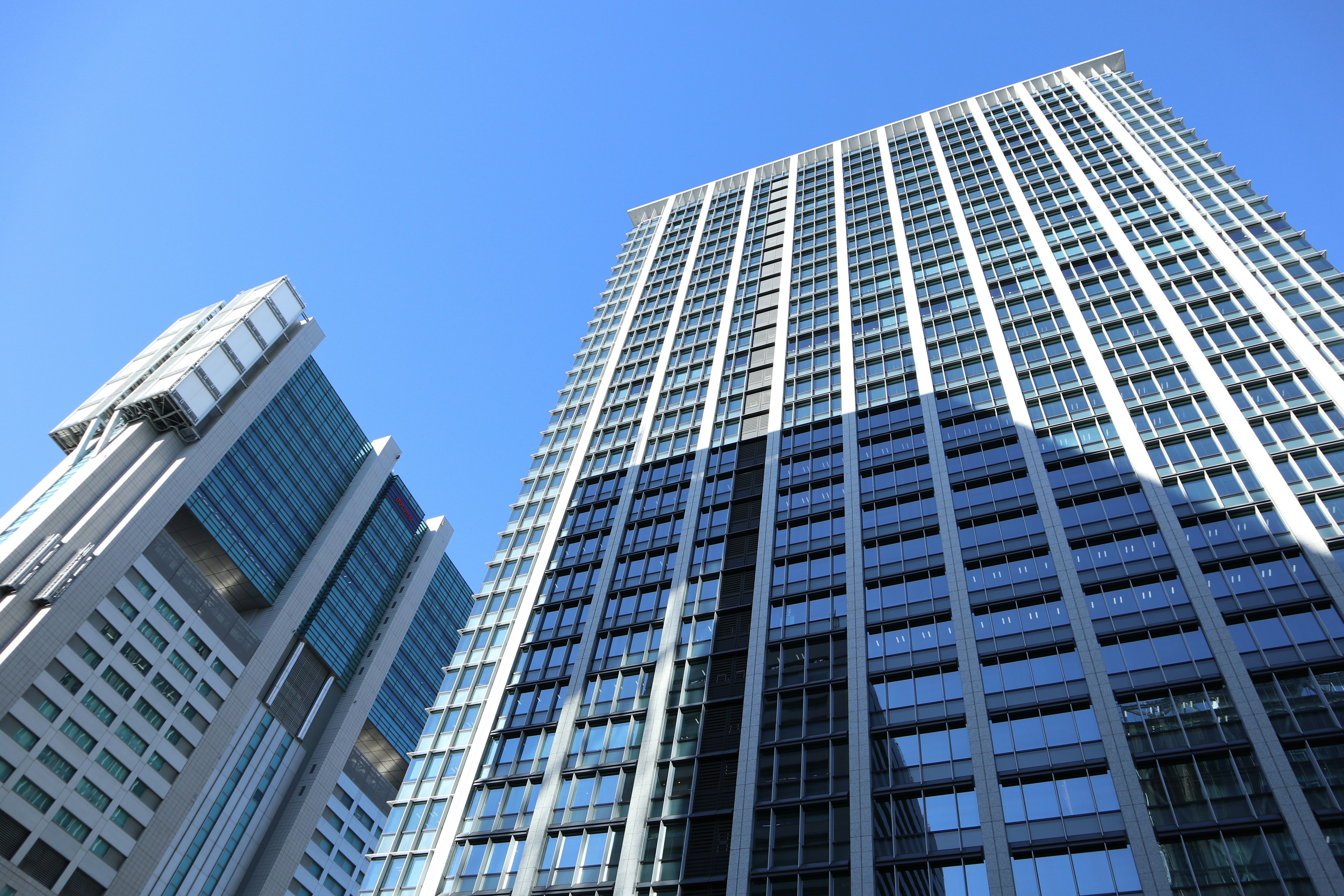 Photo of skyscrapers towering under a blue sky