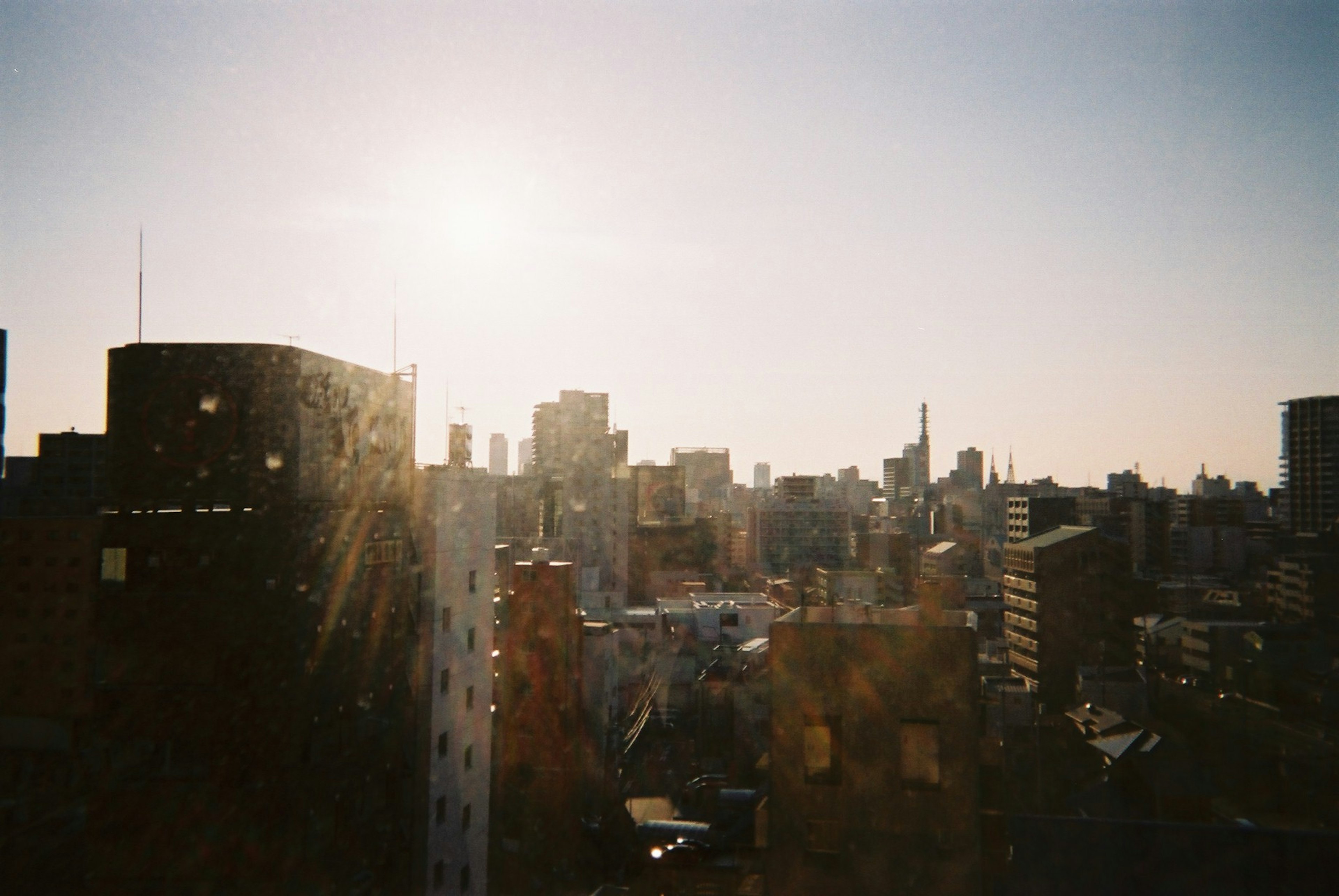 Tokyo cityscape at sunrise with buildings and bright sky