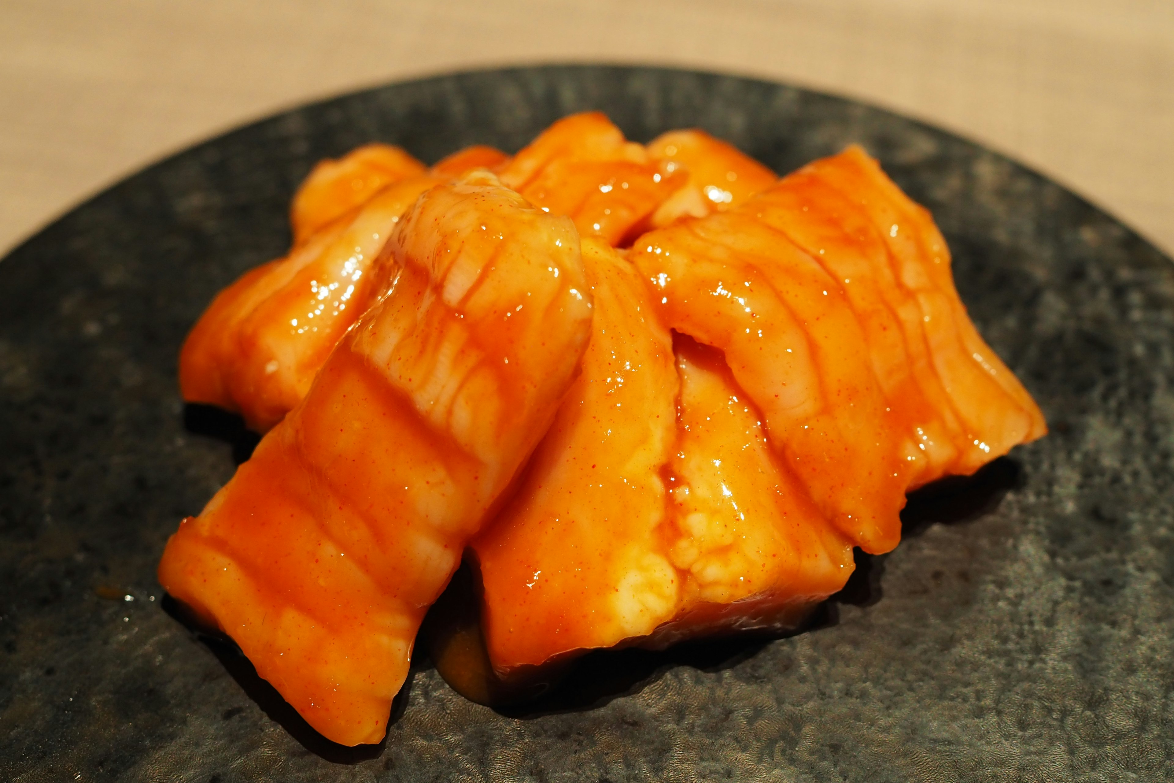 Salmon sushi arranged on a black plate