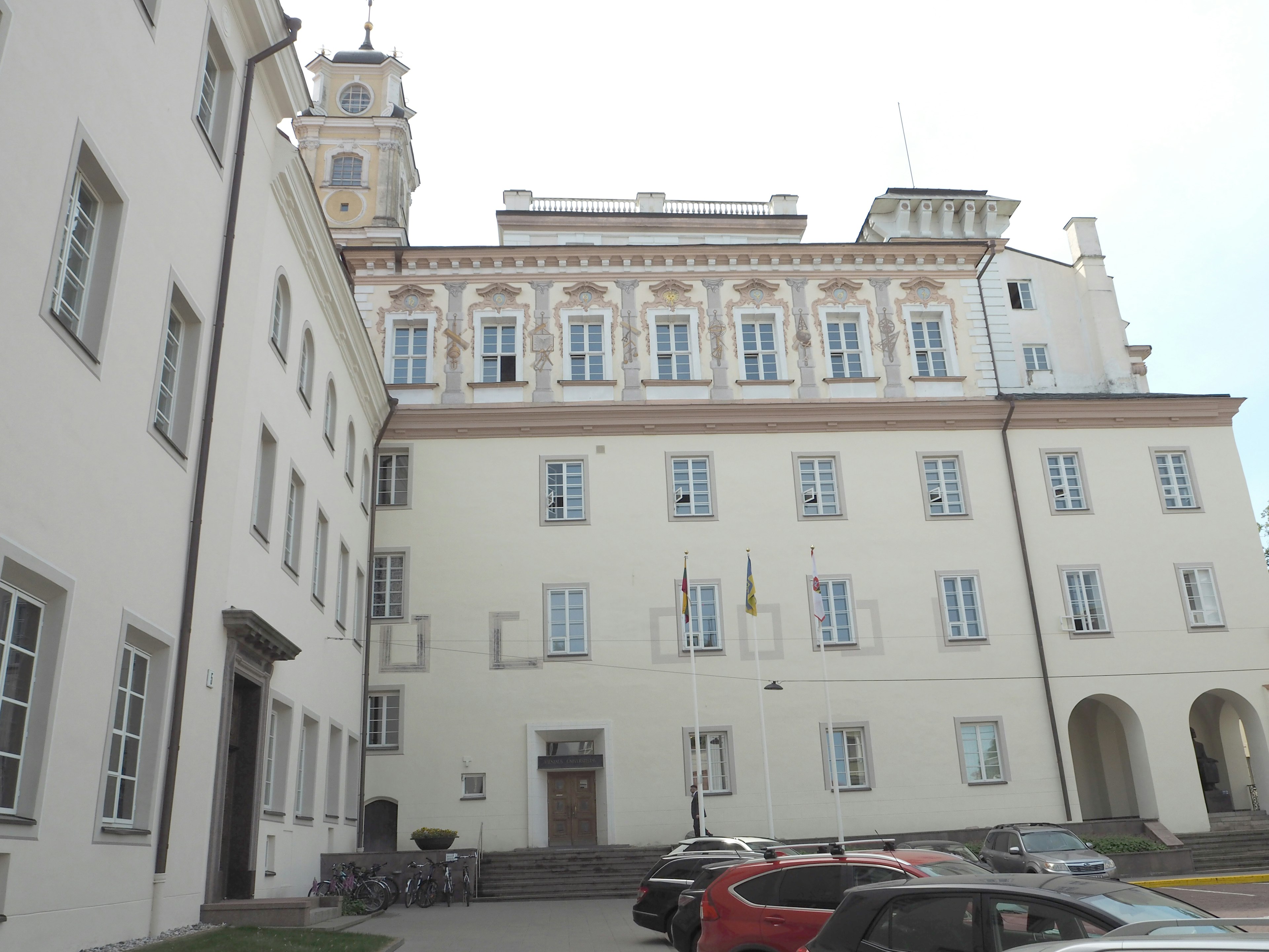 Historic building with white facade and clock tower in view