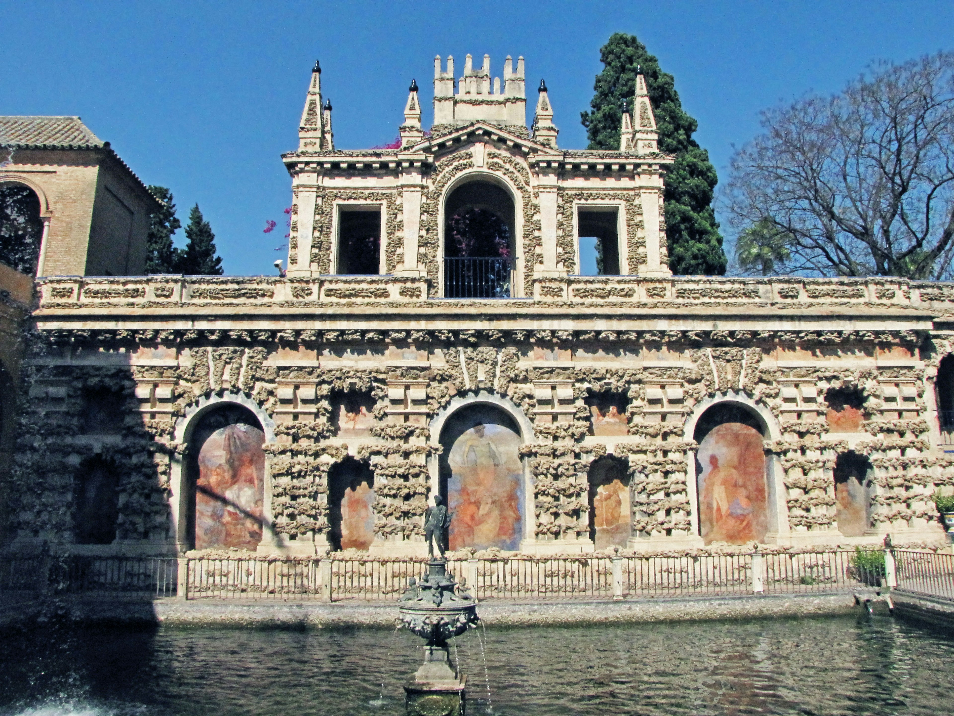 Historic building with a fountain and pond featuring intricate architecture