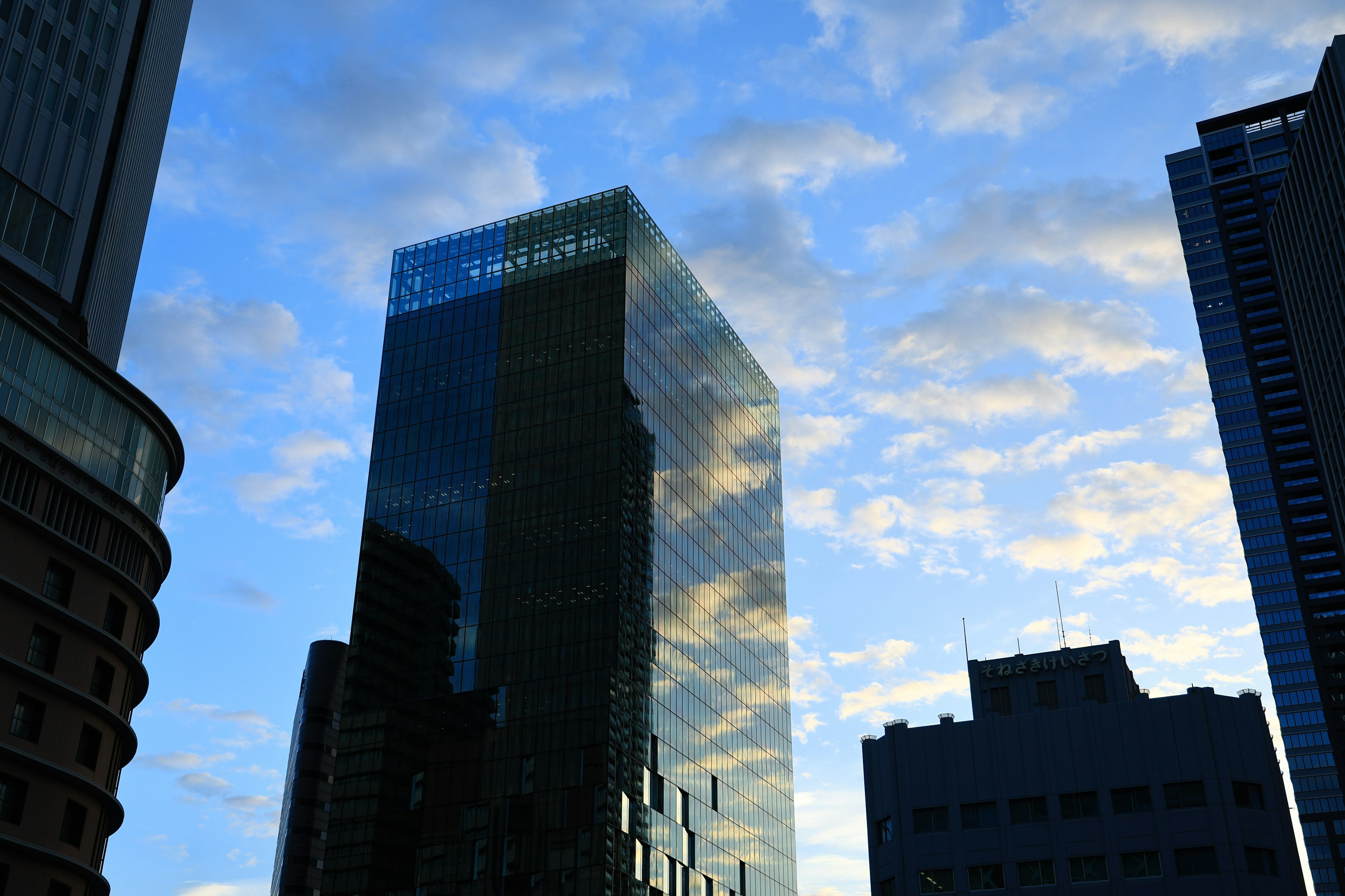 Reflection of a skyscraper against a blue sky