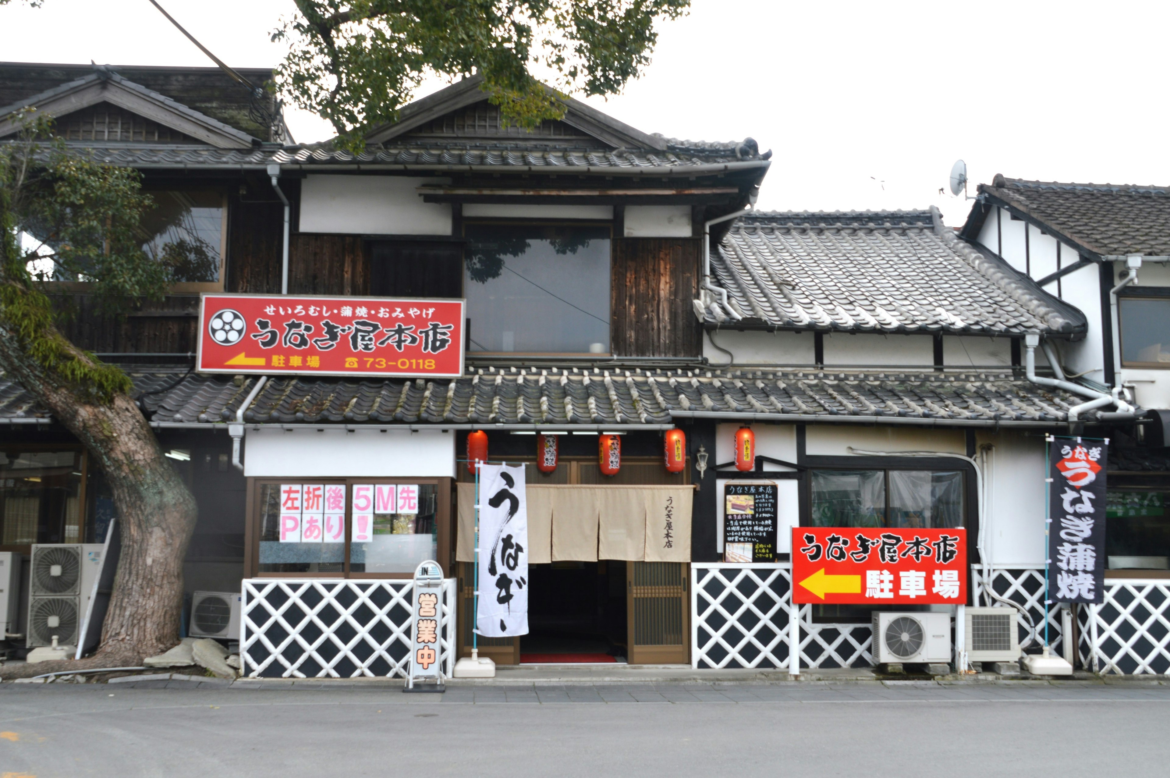 Extérieur d'un restaurant japonais traditionnel avec des panneaux rouges accrocheurs