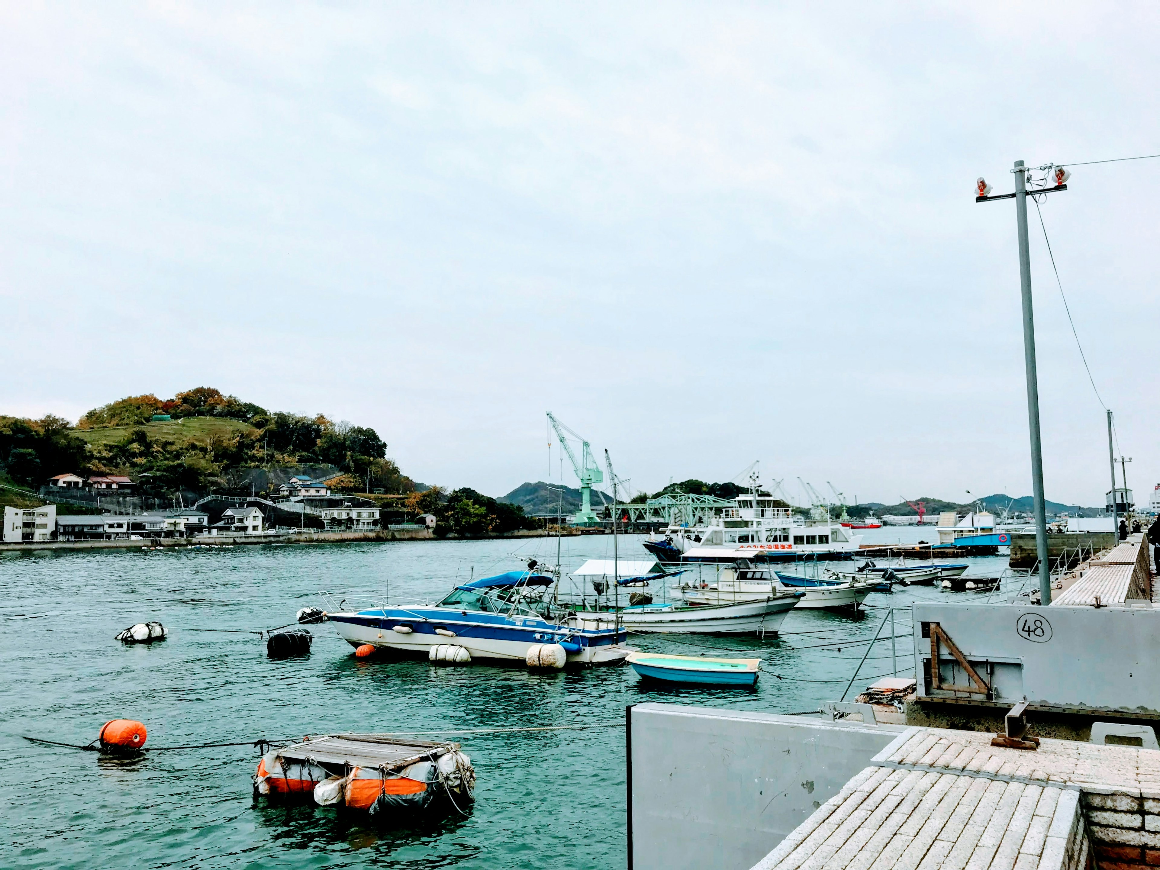 Fishing boats moored at a harbor with calm waters