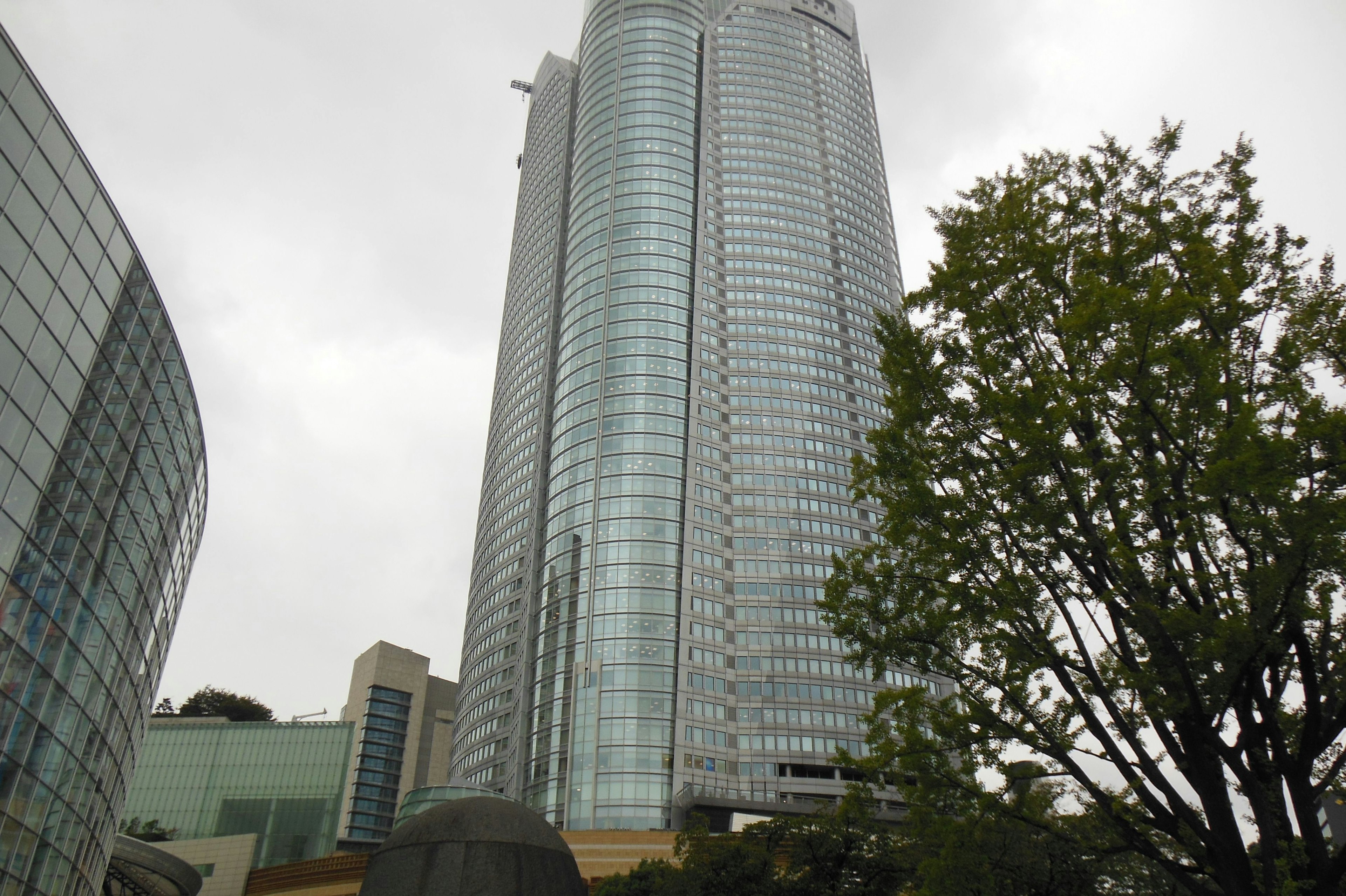 Close-up view of a skyscraper with surrounding greenery