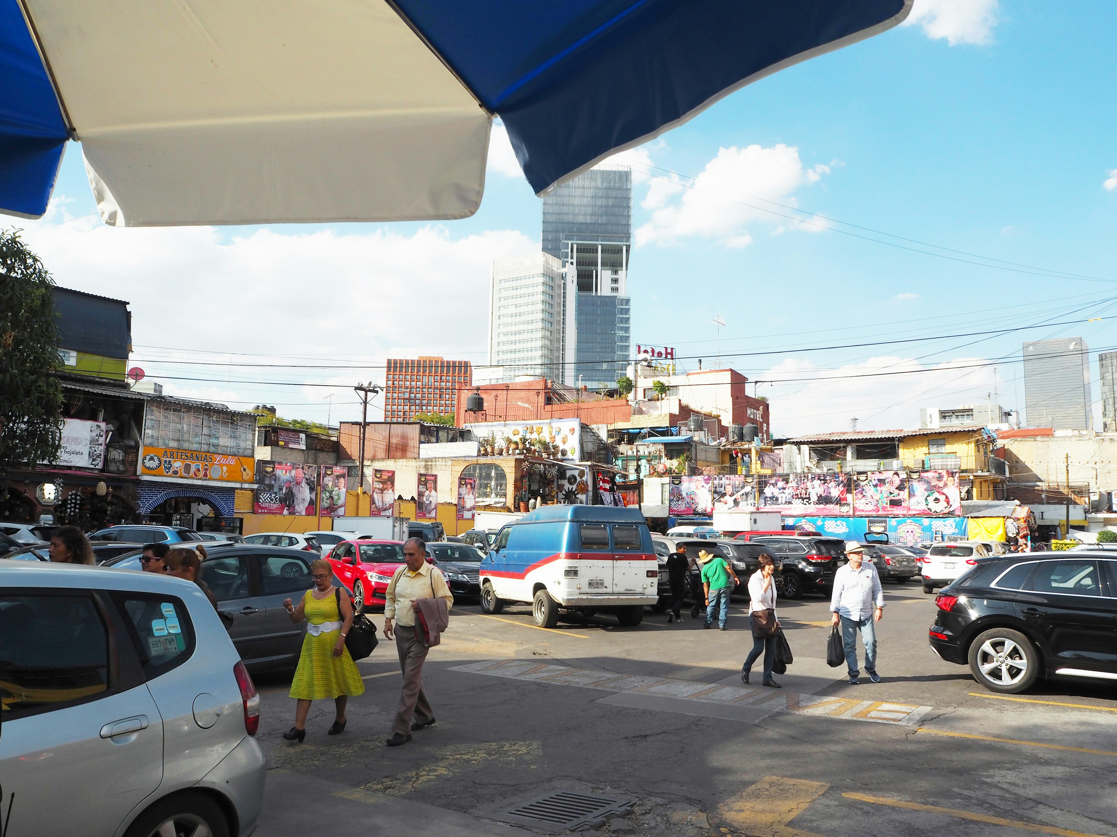 A vibrant urban scene featuring a market and skyscrapers with people walking