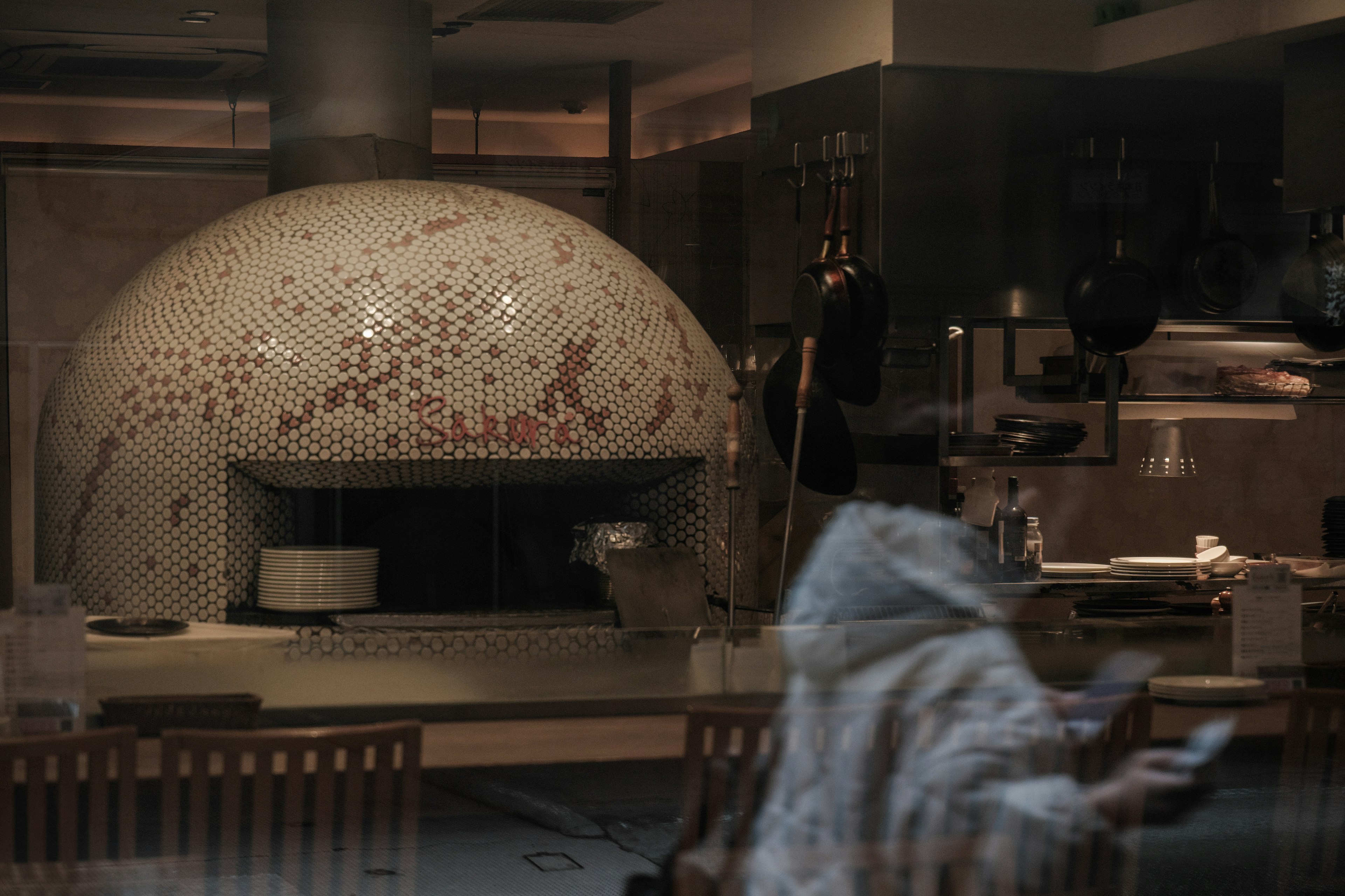 Interior of a restaurant featuring a mosaic-tiled oven