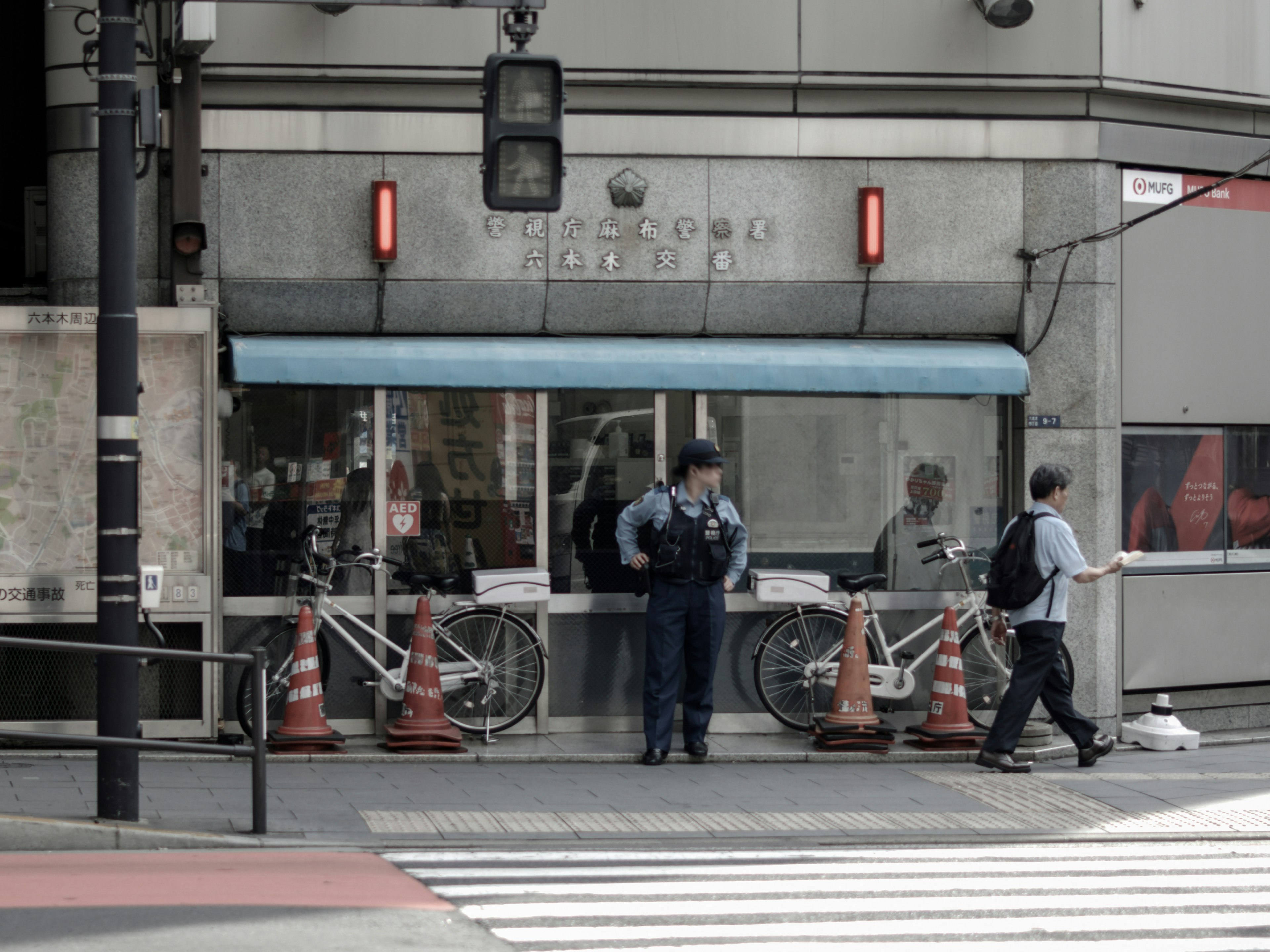 Bicycle parking area near a crosswalk with a police officer