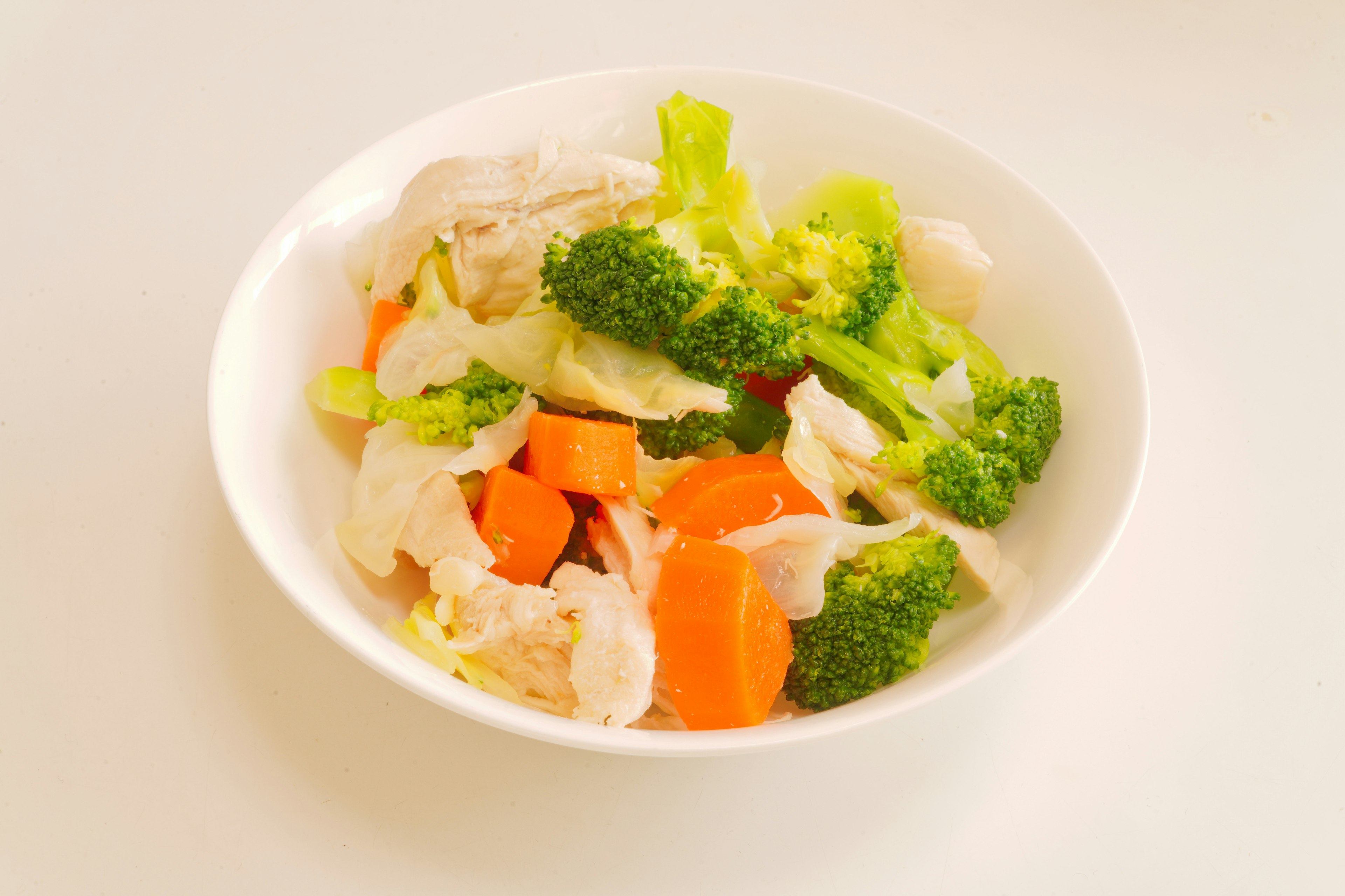 A bowl of mixed vegetables and chicken salad