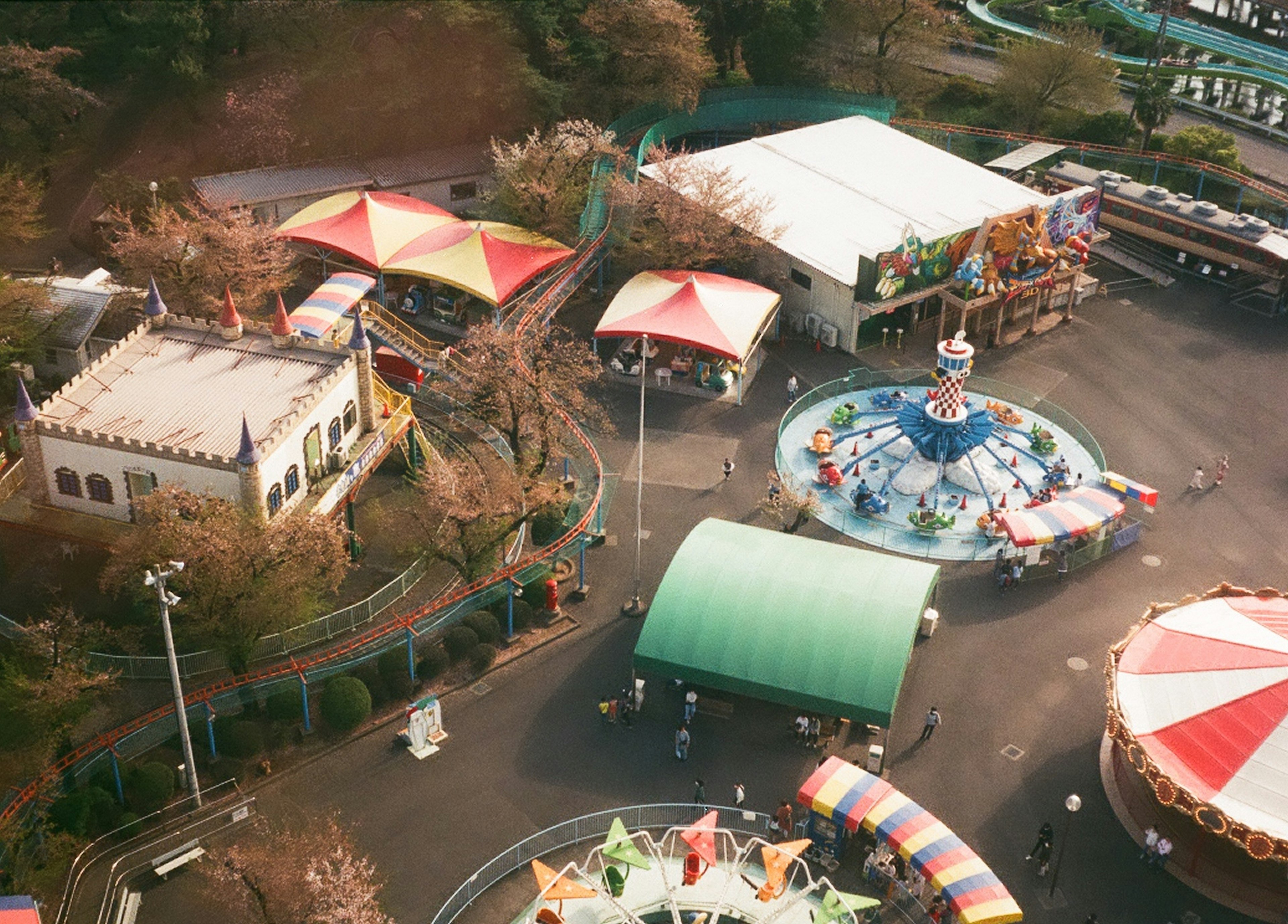 Aerial view of an amusement park featuring colorful tents and rides