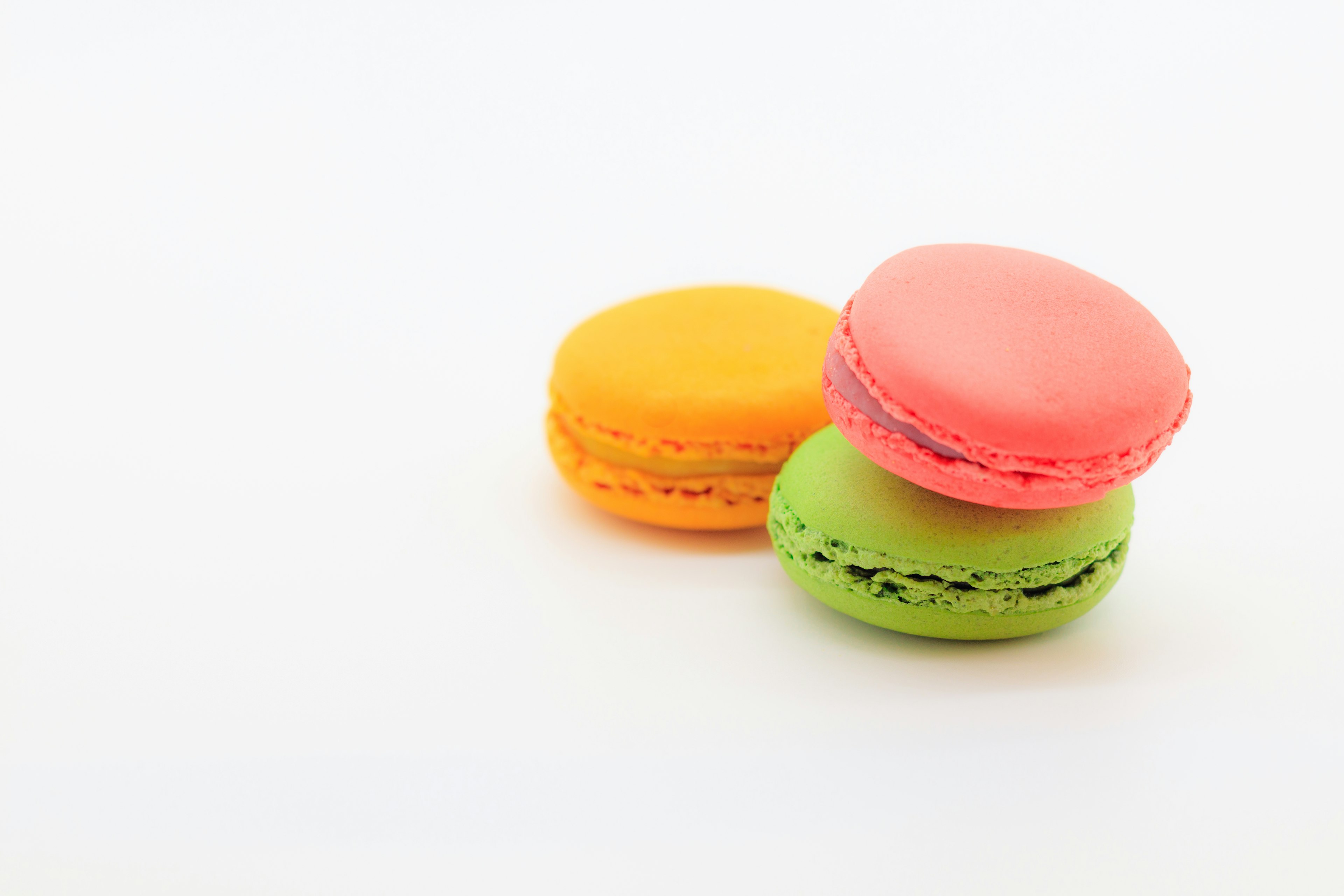 Three colorful macarons stacked together