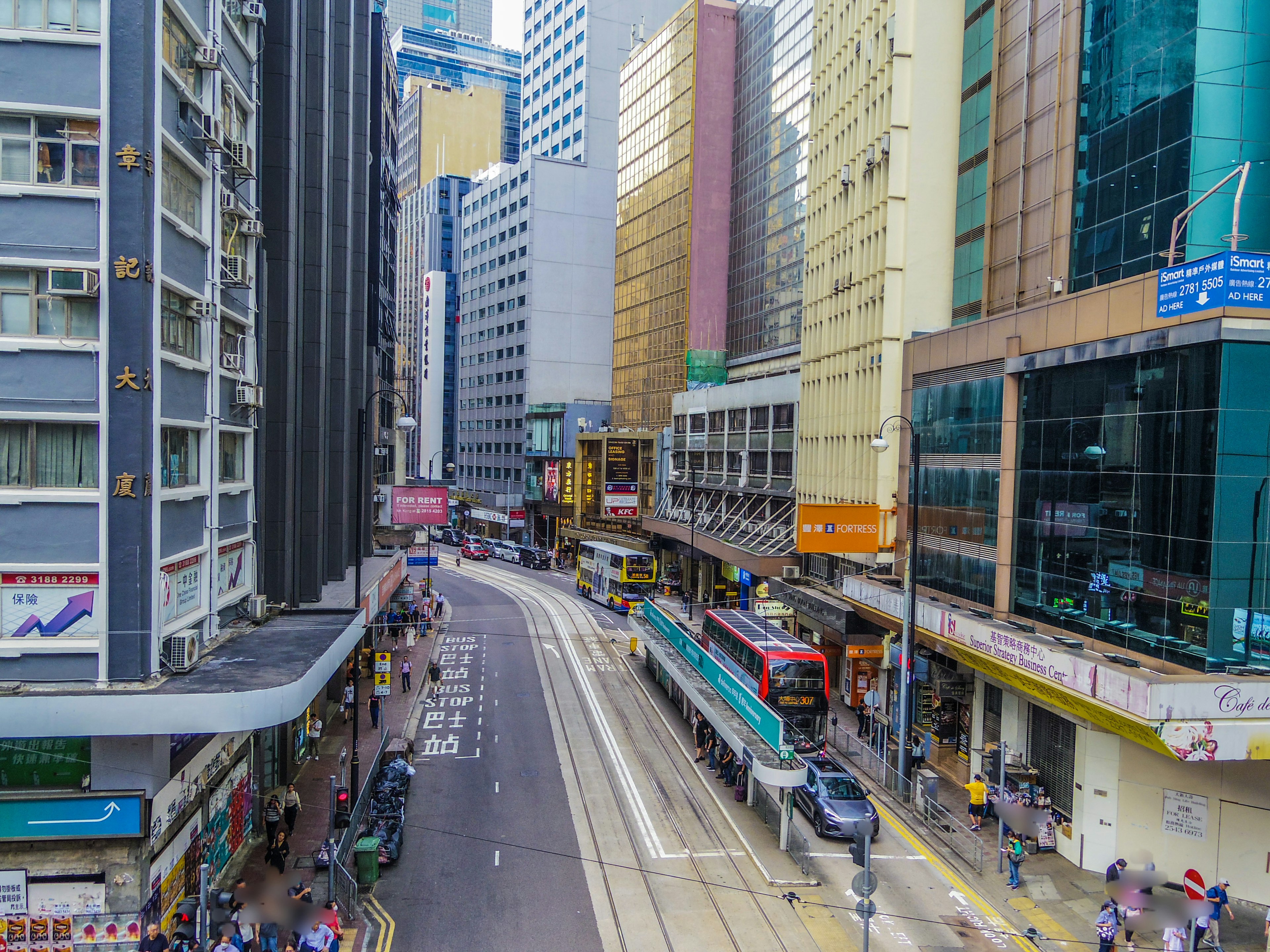 Urban cityscape featuring skyscrapers and a tram on the road