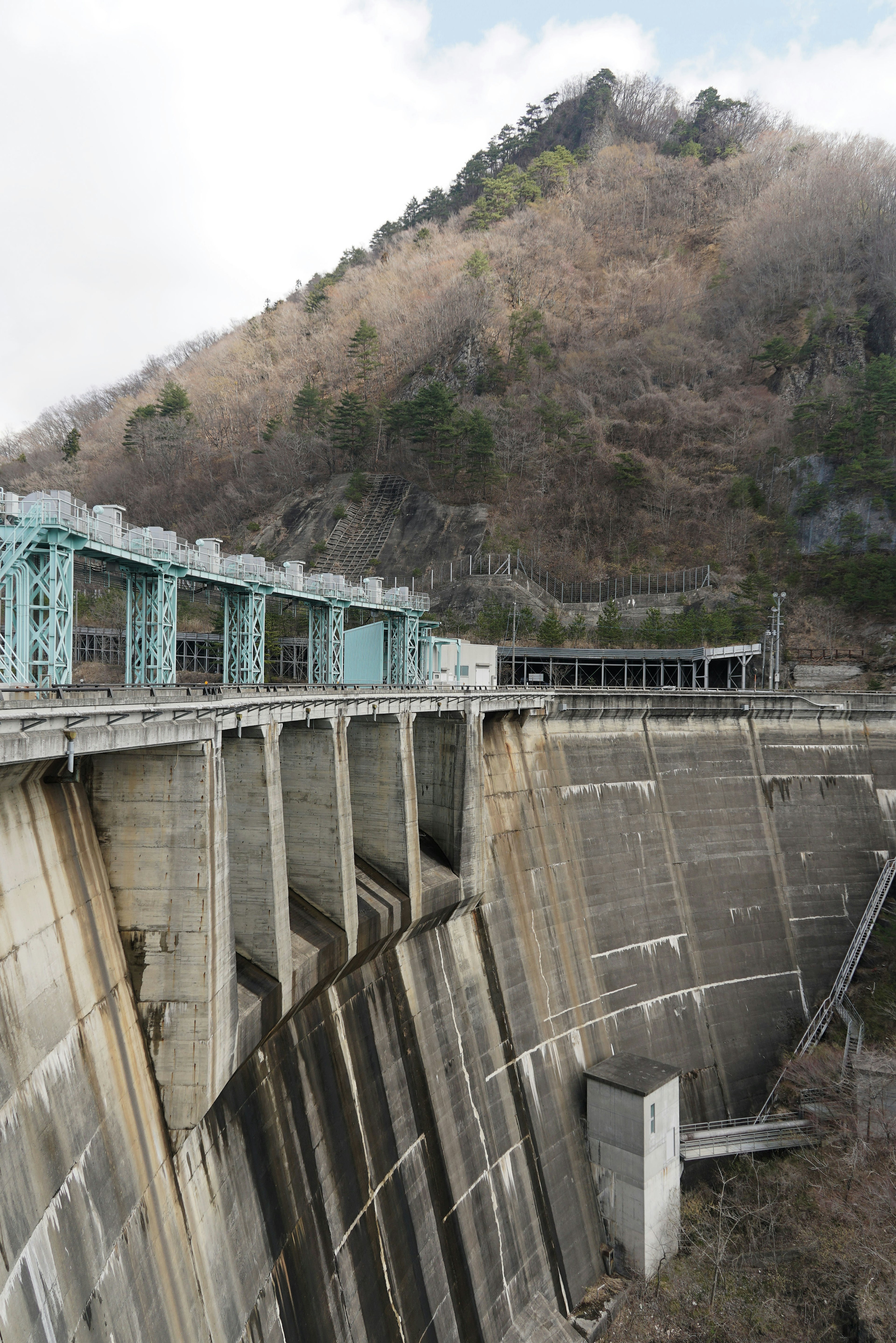 Landscape featuring a dam structure against a mountainous background