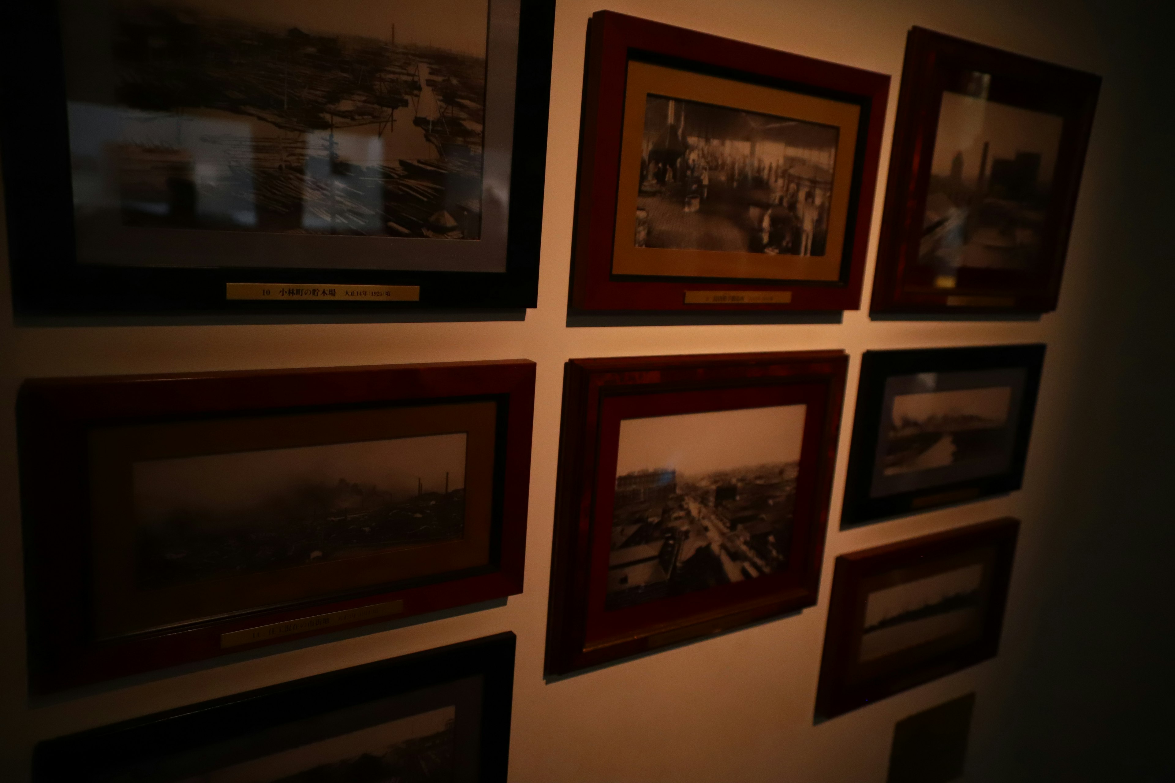 Collection of historical photographs framed on a wall