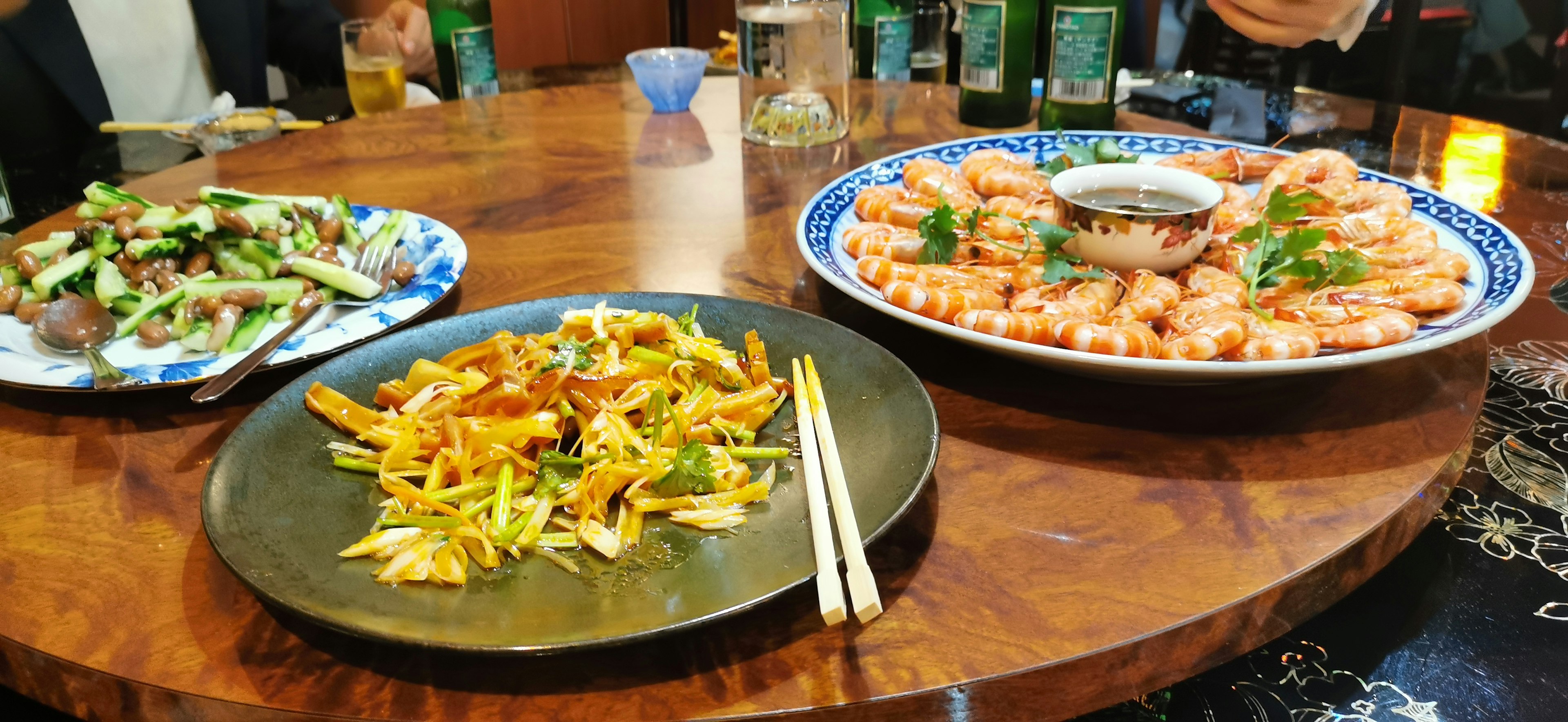 Table filled with shrimp dishes and vegetable platter