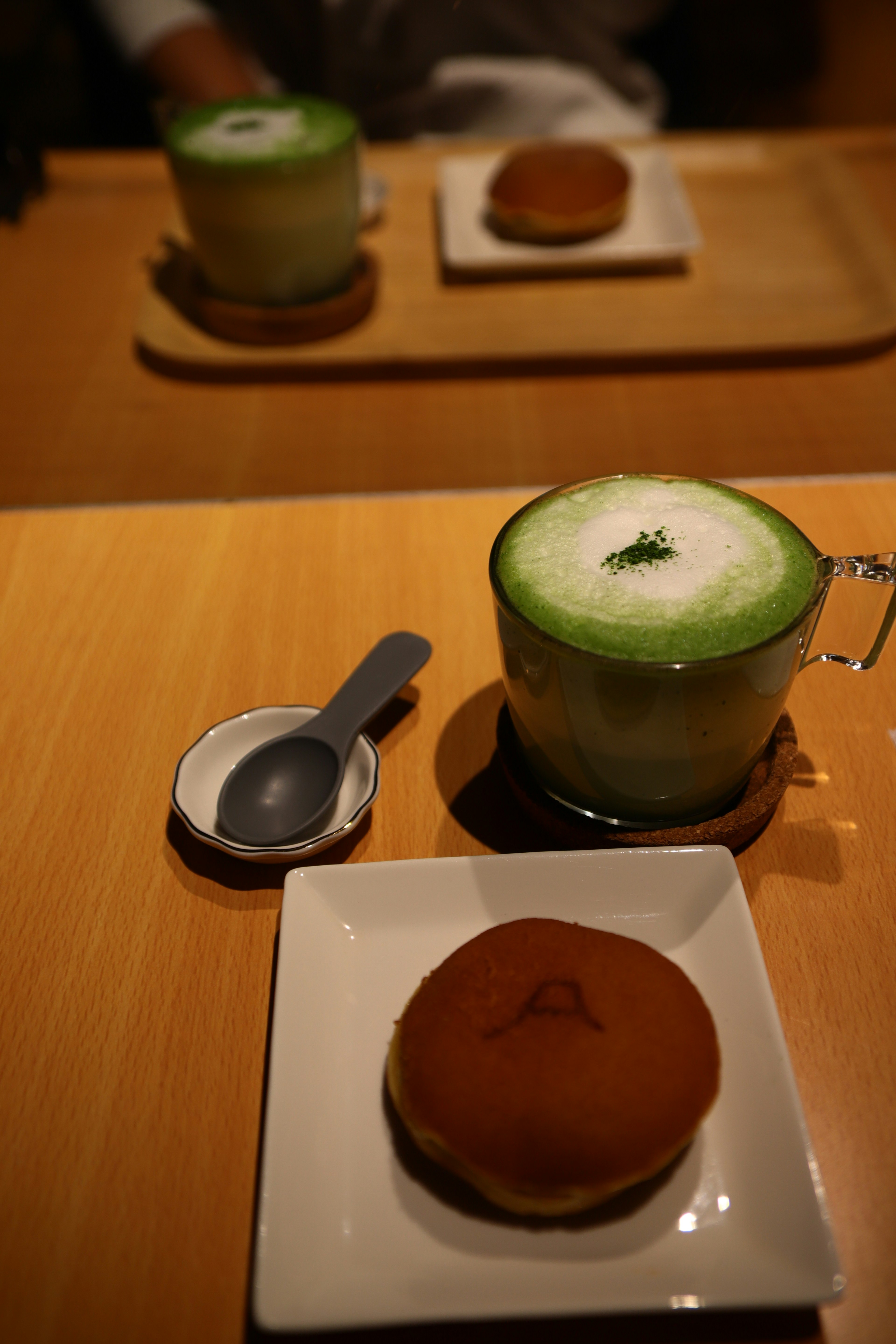 Matcha latte and dorayaki on a wooden table