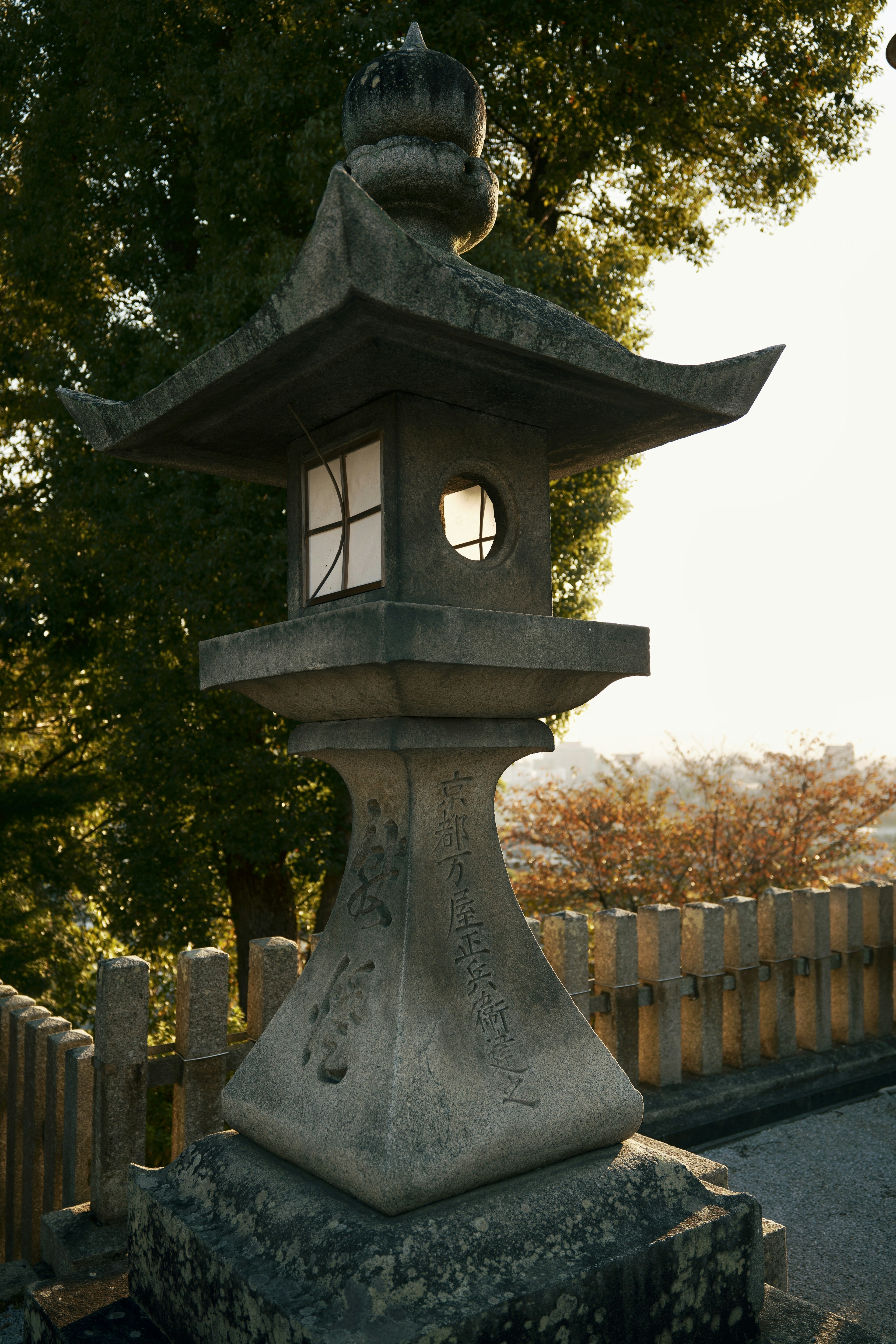 A stone lantern stands amidst a beautiful landscape