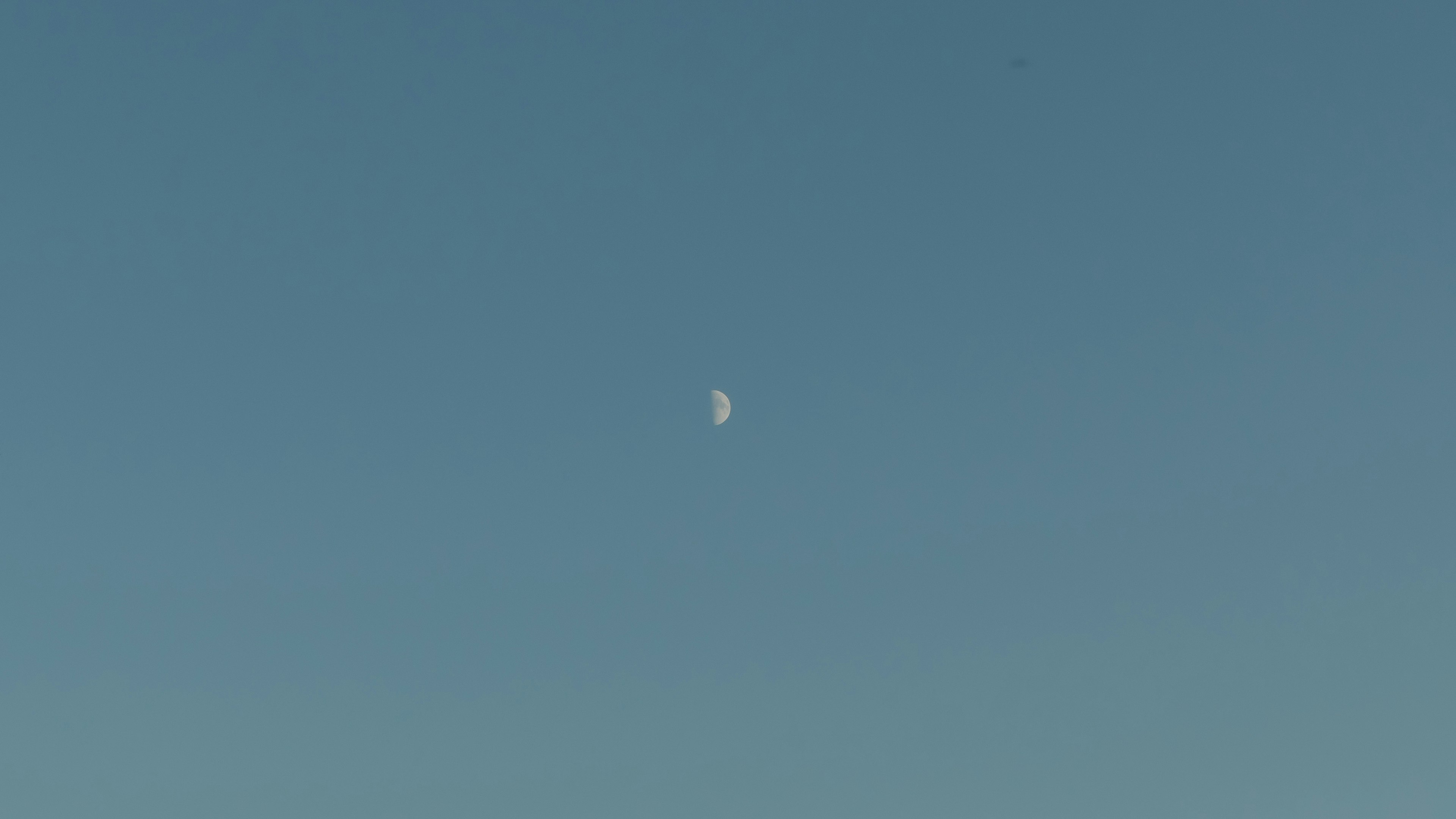 White object floating in a blue sky