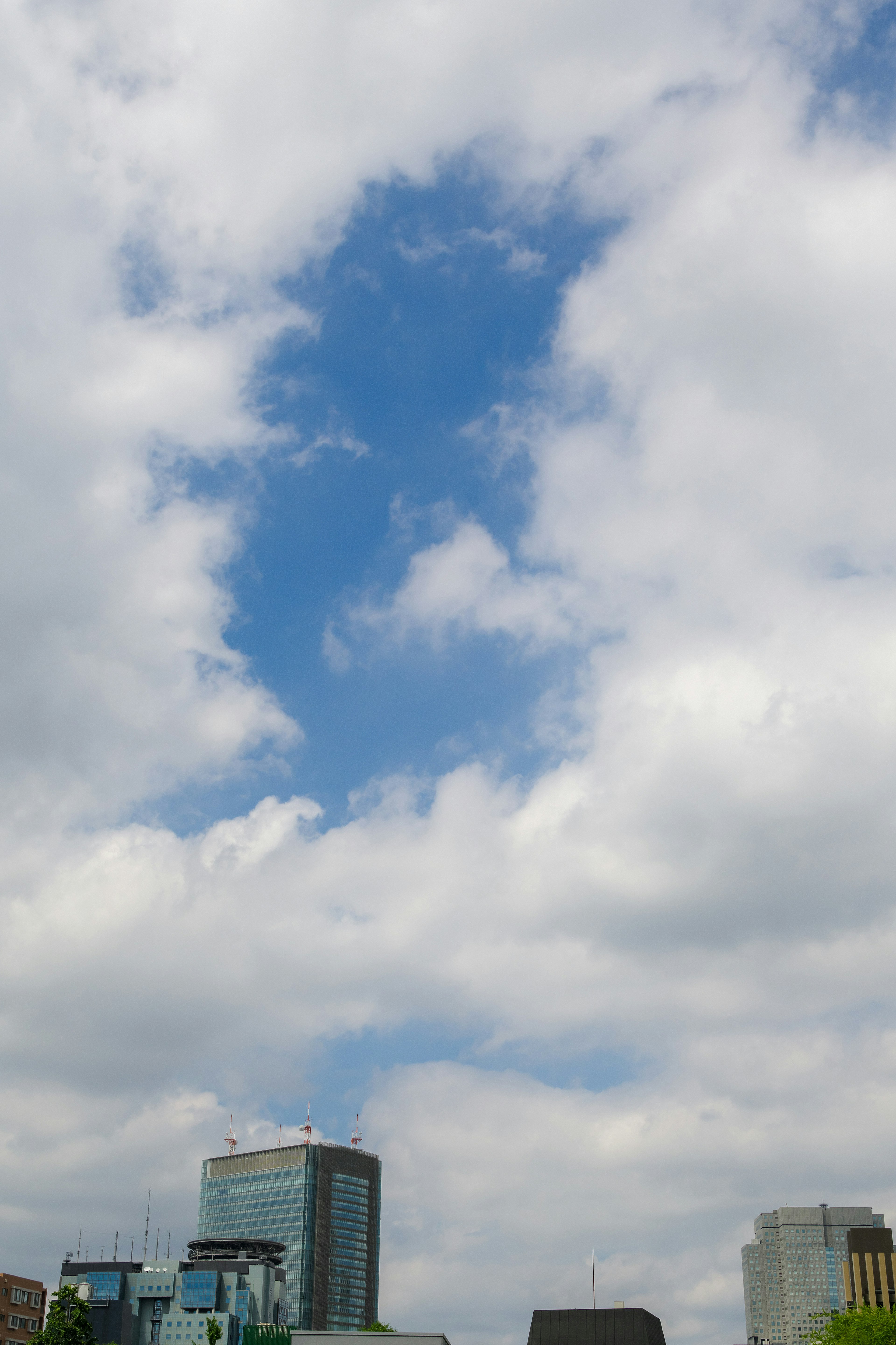 Urban skyline with blue sky and white clouds