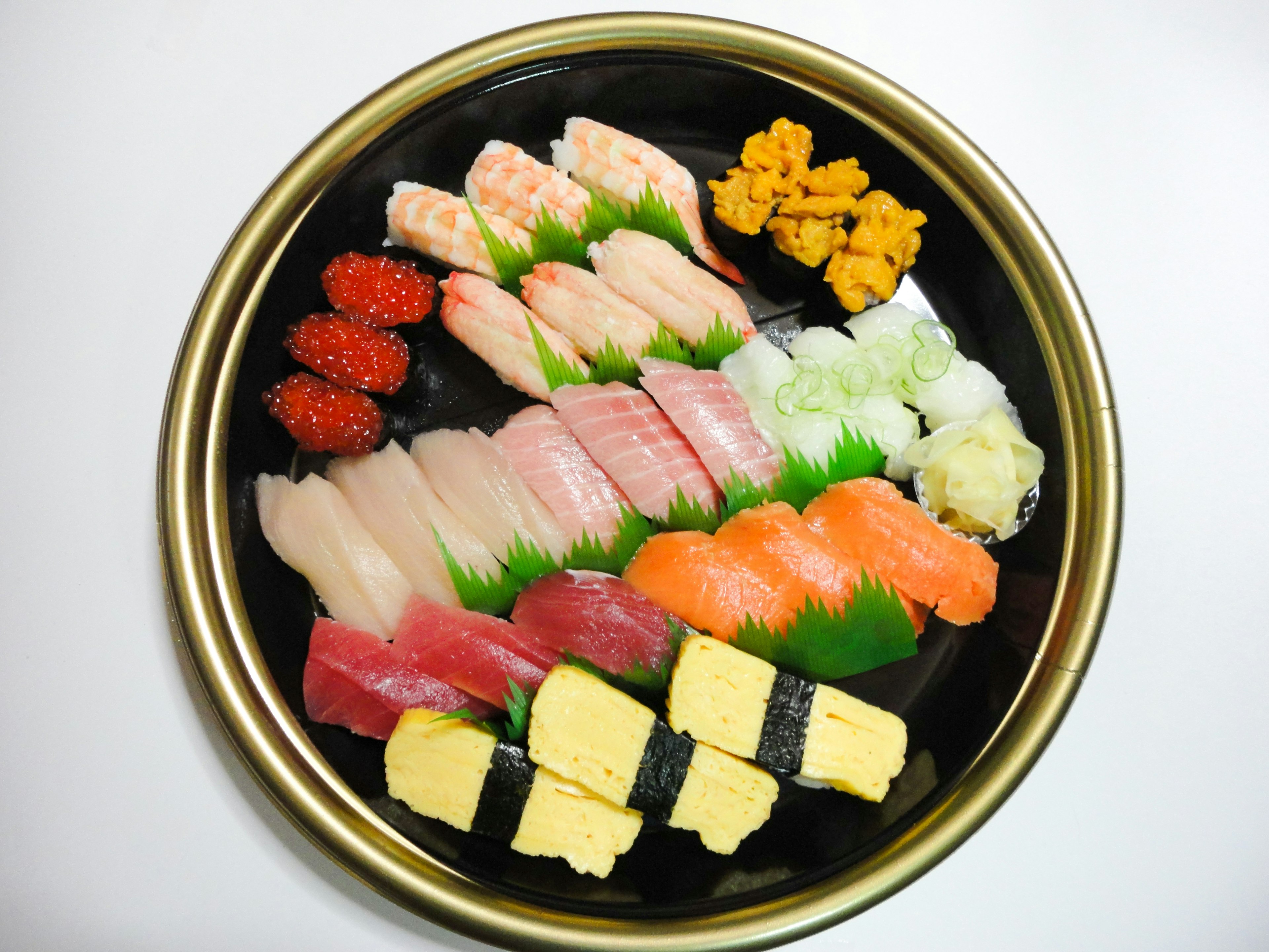 A platter of assorted sushi with vibrant colors and various toppings