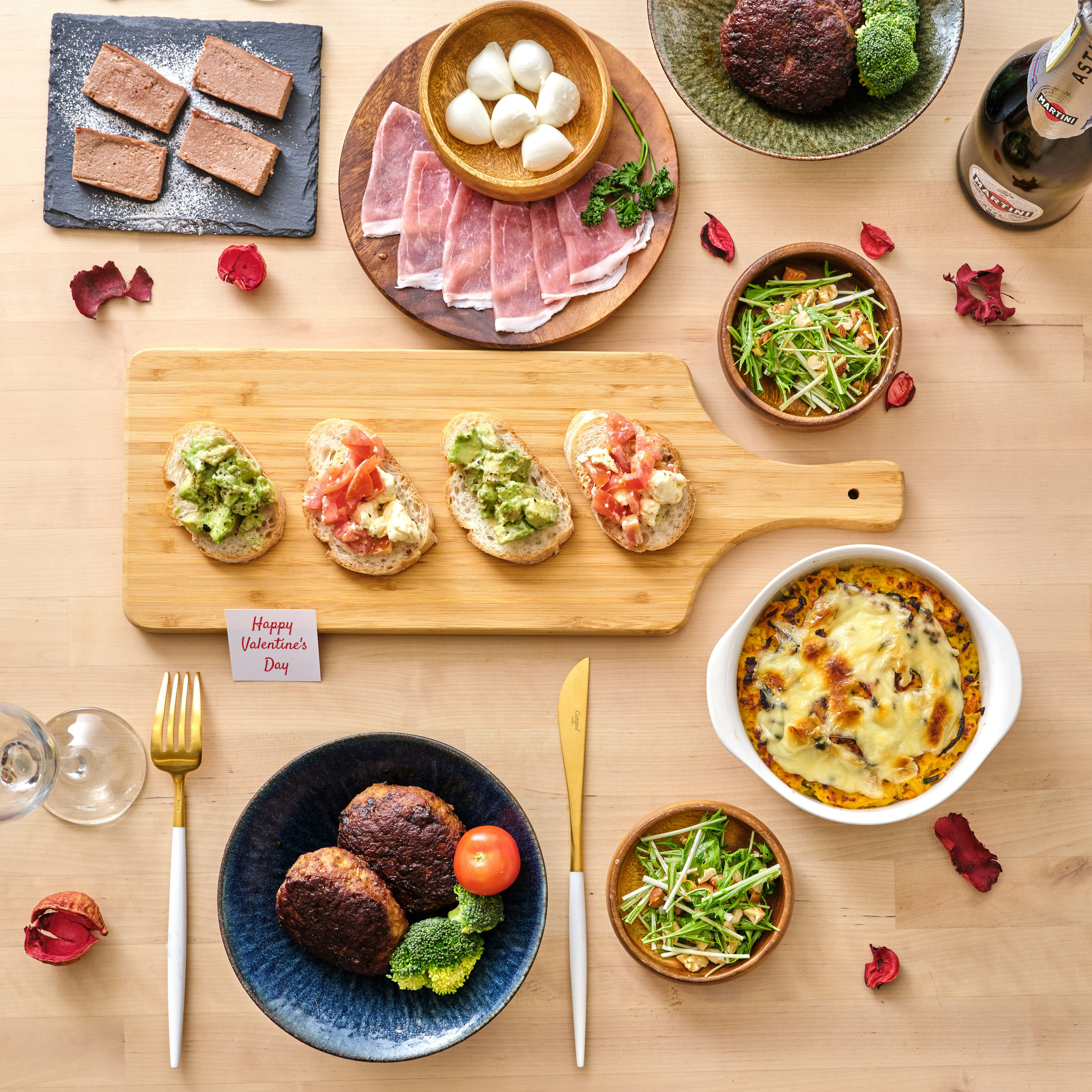 A beautifully arranged dining table featuring various colorful dishes