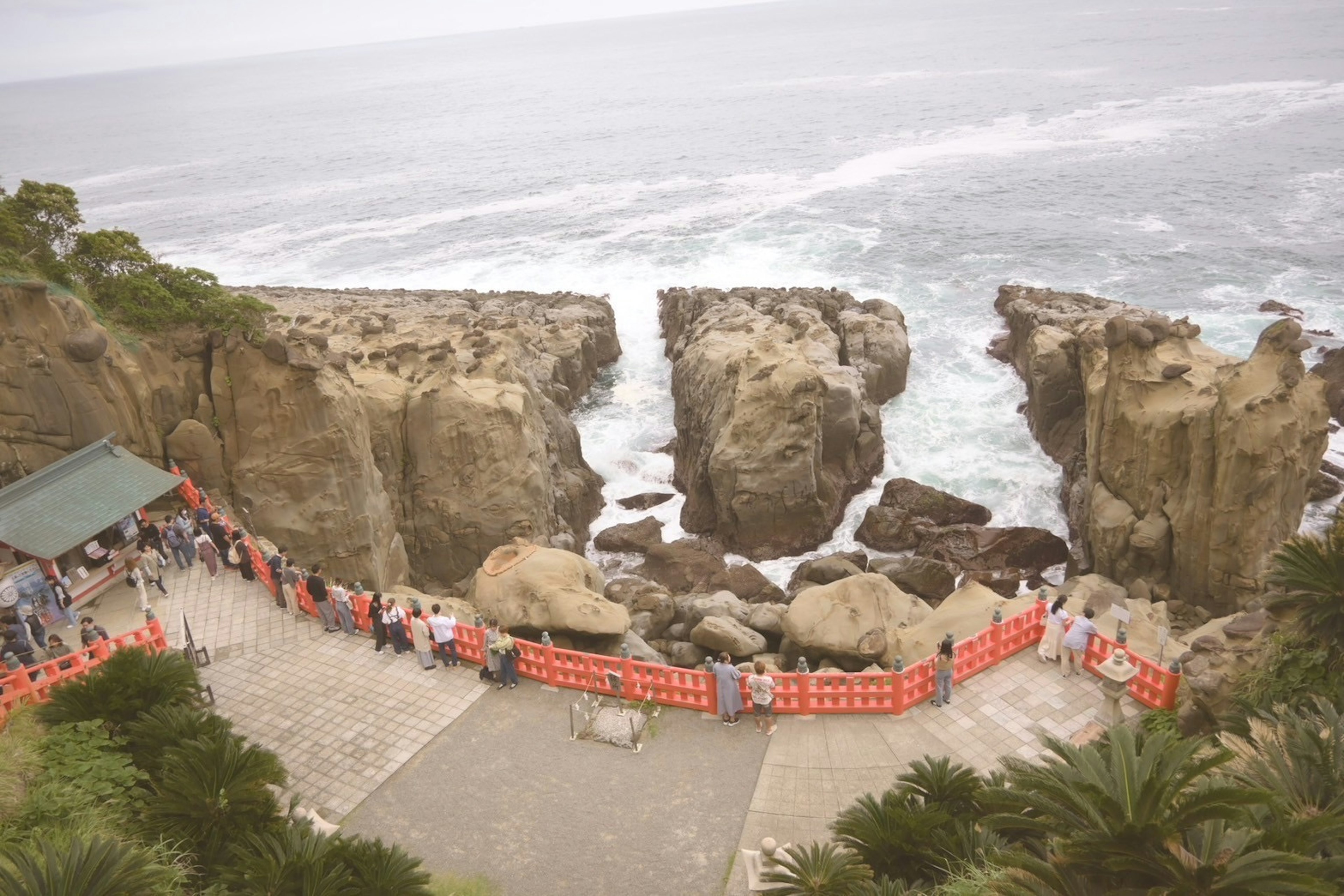 Coastal view with people gathered around rock formations