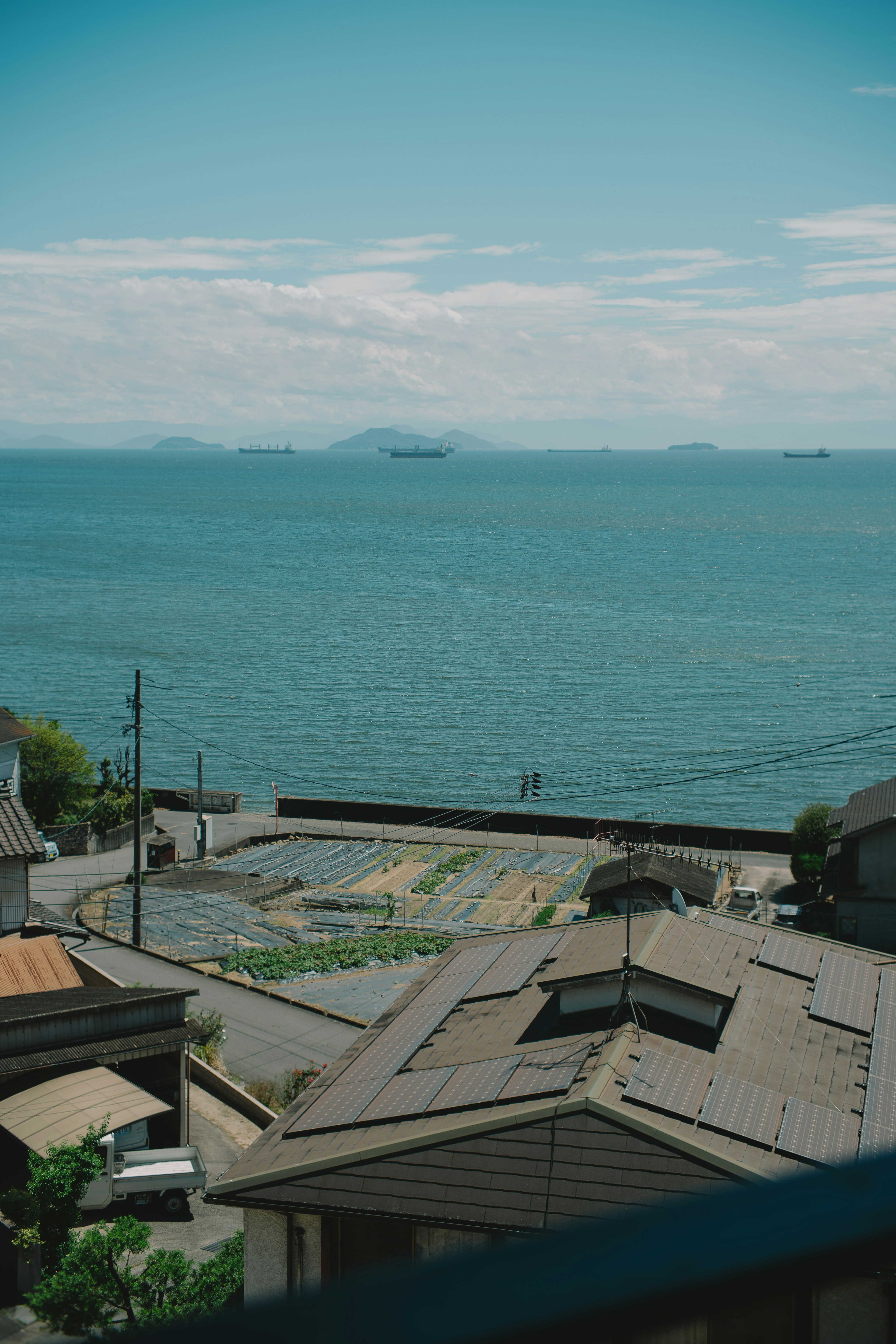 View of blue ocean and sky with rooftops