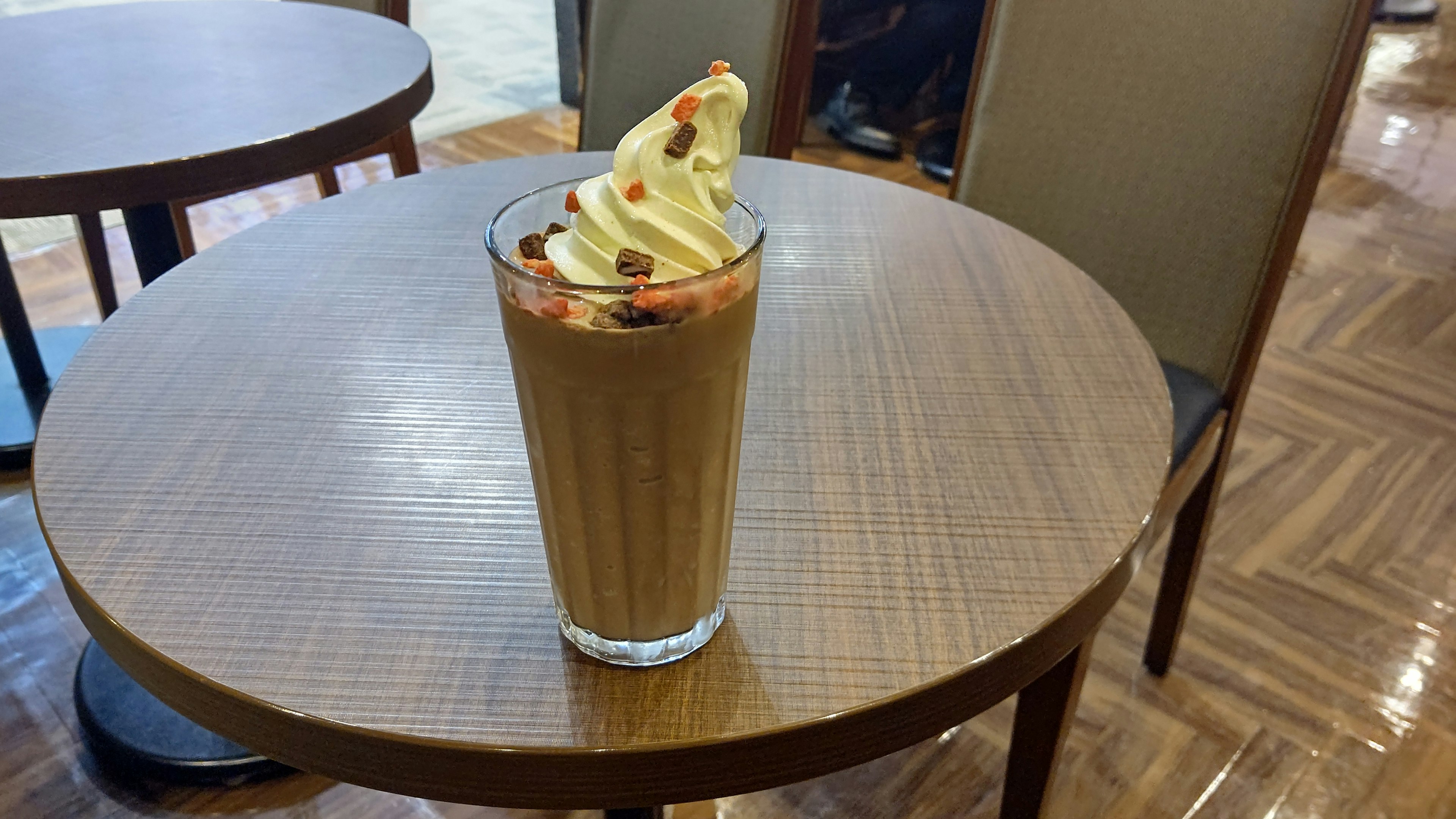 Coffee drink topped with cream placed on a table