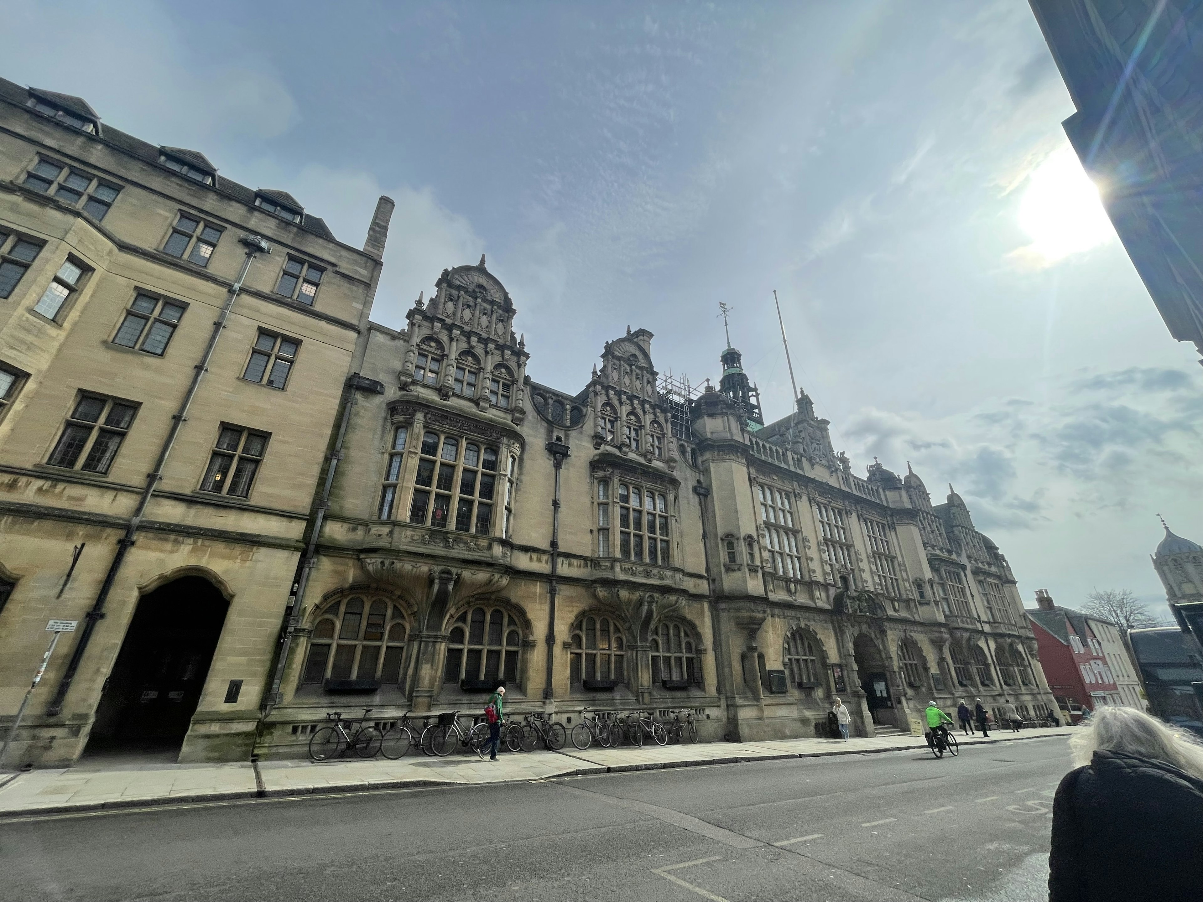 Historic Oxford architecture with intricate details and a bright sky