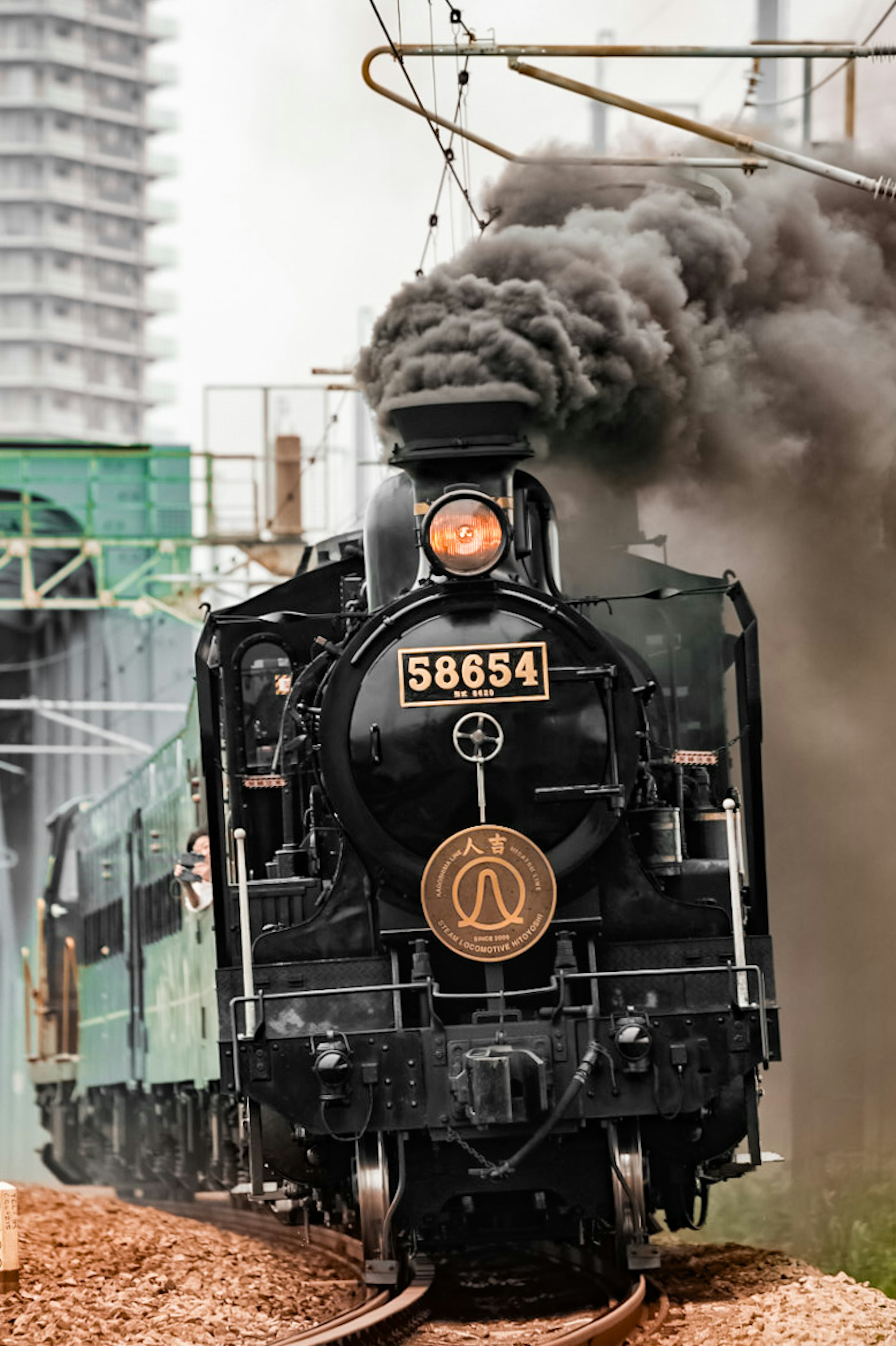 Vintage steam locomotive 58654 billowing smoke while in motion