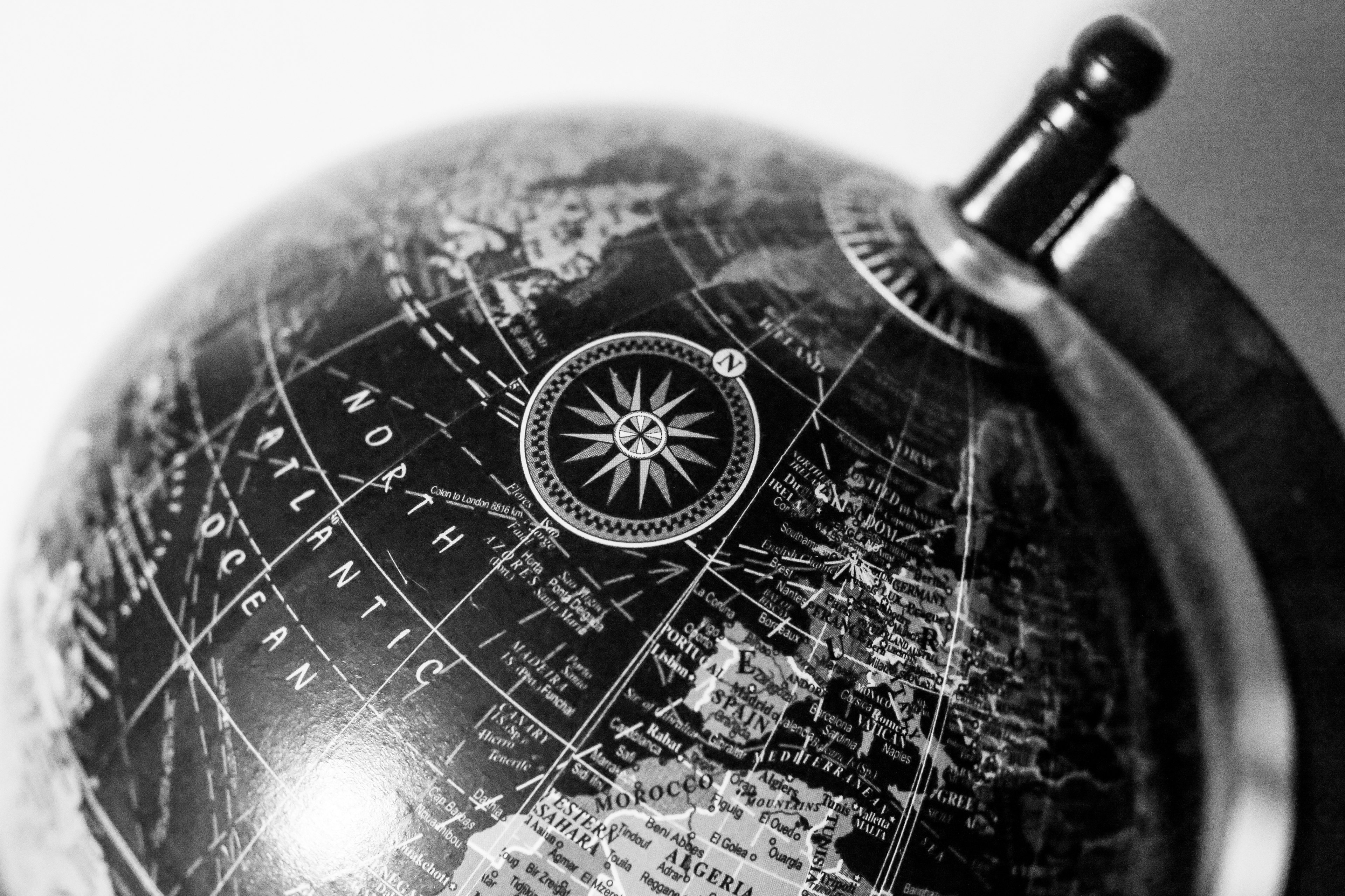 Close-up of a black globe featuring detailed map of the Northern Hemisphere with compass design