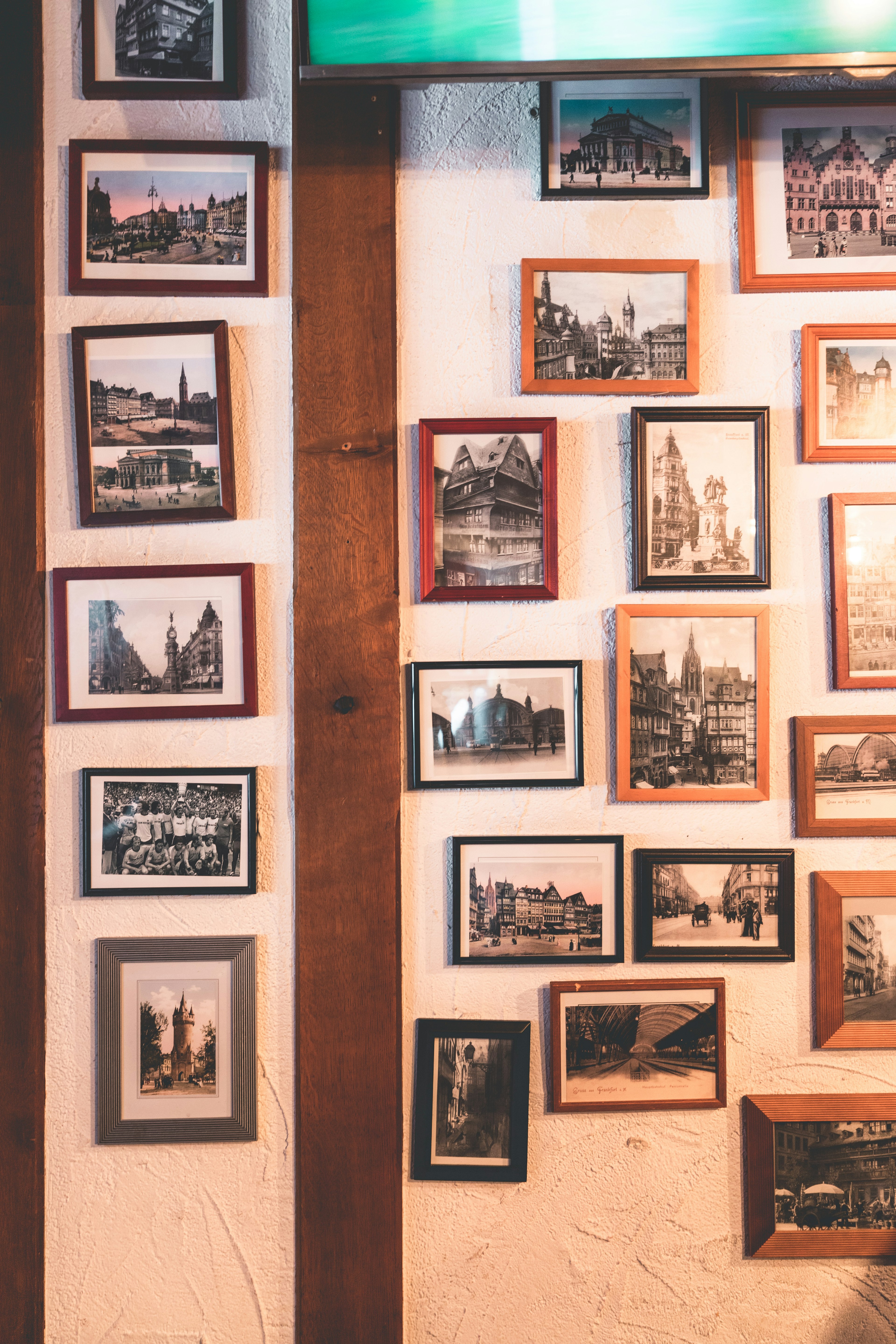 A wall adorned with various black and white framed photographs