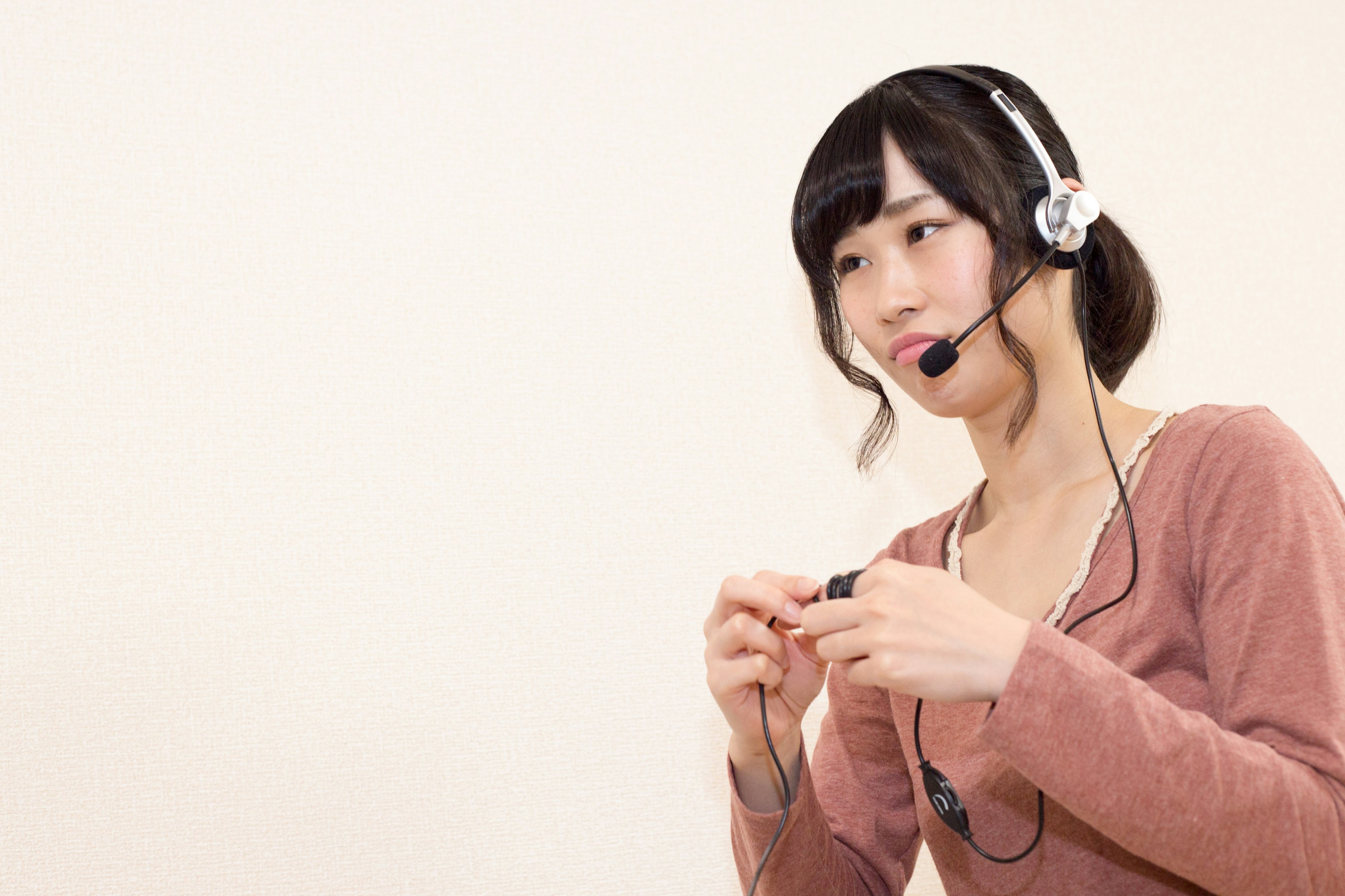 A woman wearing a headset appears focused